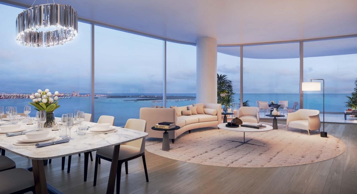 This brand-new 5-bedroom, 6.5-bath bayfront residence at UNA offers breathtaking, unobstructed views of Biscayne Bay, the Atlantic Ocean, and the Miami skyline. Spanning 4,725 interior square feet plus 797 square feet of expansive terraces, the residence includes a den and dedicated housekeeping quarters. Offering exceptional privacy with just two residences per floor, the home features private elevator entry into a flow-through layout. Floor-to-ceiling "lift-and-glide" glass doors, glass balcony railings, and 10’8” ceilings flood the home with natural light and seamless indoor-outdoor living. The chef’s kitchen is equipped with Gaggenau appliances, including induction cooktop and integrated refrigeration. The primary suite features separate his-and-hers bathrooms and walk-in closets. Amenities include three pools, jacuzzi, children’s splash area, state-of-the-art gym with personal training and yoga, spa with steam room and sauna, private movie theater, dog walk area, BBQ and entertaining spaces, and lush gardens designed by Enzo Enea. Designed by Adrian Smith + Gordon Gill Architecture, UNA is inspired by the elegant shapes and refined materials of classic yacht design, minutes from Brickell, Coconut Grove, Downtown, and Key Biscayne.
