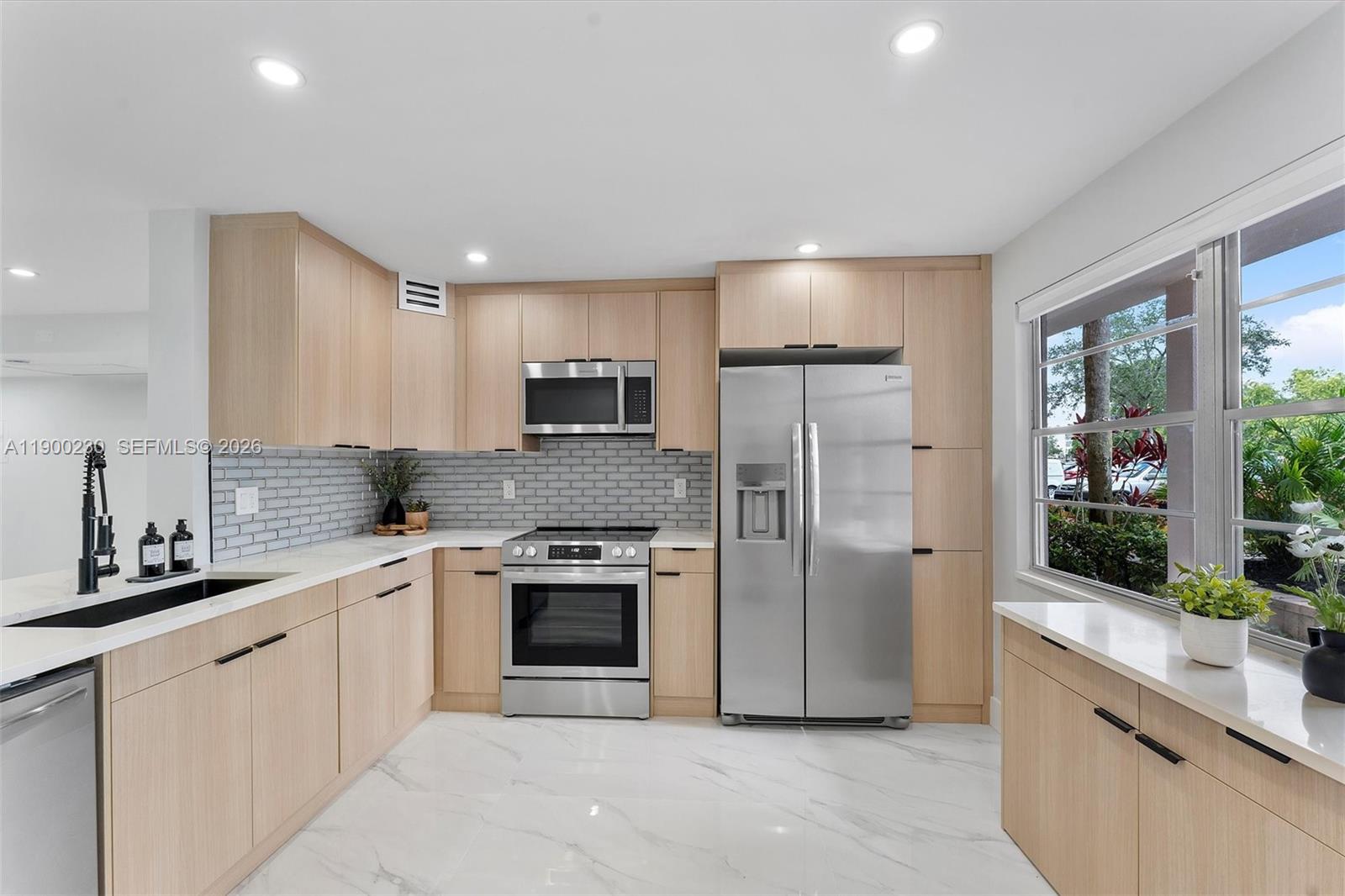 GORGEOUS, COMPLETELY REMODELED WITH PERMITS! This stunning ground-floor residence offers the perfect blend of style and convenience. Enjoy the ease of parking right in front of your door and direct access to the heated pool just moments from your patio, creating a true resort-style lifestyle. The beautifully updated interior features modern finishes and the added convenience of a washer and dryer inside the unit.

Located in a full-service 55+ community, residents enjoy an incredible array of amenities including on-site restaurants, clubhouse, community rooms, business center, fitness center, pickleball courts, golf course, movie theater, multiple heated pools, countless social clubs, and a free community shuttle for easy transportation.

For peace of mind, the building has successfully passed the 30-year inspection and completed the SIRS requirements, with NO assessments. Move in and start enjoying the lifestyle immediately!