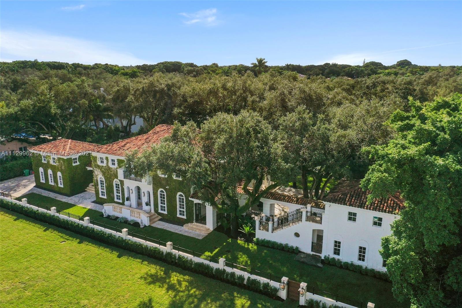 Sunset Villa - A custom-built Mediterranean estate in prime Coral Gables location! Comprised of 3 structures for ultimate flexibility, the main residence features four large bedrooms w/central den upstairs. Wonderful living areas and an open kitchen concept downstairs all with 14' ceilings. All rooms are oversized with great natural light & windows. Connected via breezeways are 2 guest suites located above the 2-car garage and a 2-story gym/office/bedroom overlooking the salt-water pool. Mature oak trees create privacy and serenity. Ample covered terraces and open-air patios abound for entertaining and relaxation with family and friends. Smart-house system for audio/visual/lighting. The property is fully gated and secure. Newly polished Brazilian cherry and marble flooring.