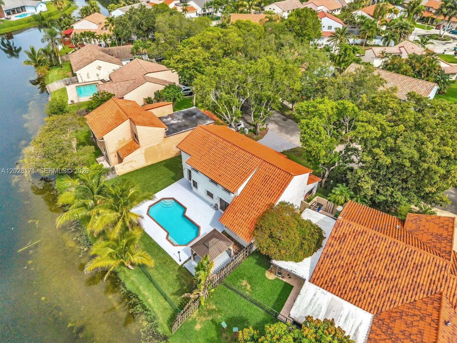 Beautiful waterfront pool home available for rent in the highly sought-after Rock Creek community of Cooper City. Situated on an oversized lot, this spacious residence offers 5 bedrooms, 3 full bathrooms, and a versatile loft ideal for a home office, guest room, or additional living space.
Enjoy an open, light-filled floor plan with soaring ceilings, updated kitchen finishes, and stunning water views. The private backyard features a sparkling pool, covered patio, fenced yard, and peaceful waterfront setting- perfect for relaxing or entertaining.
