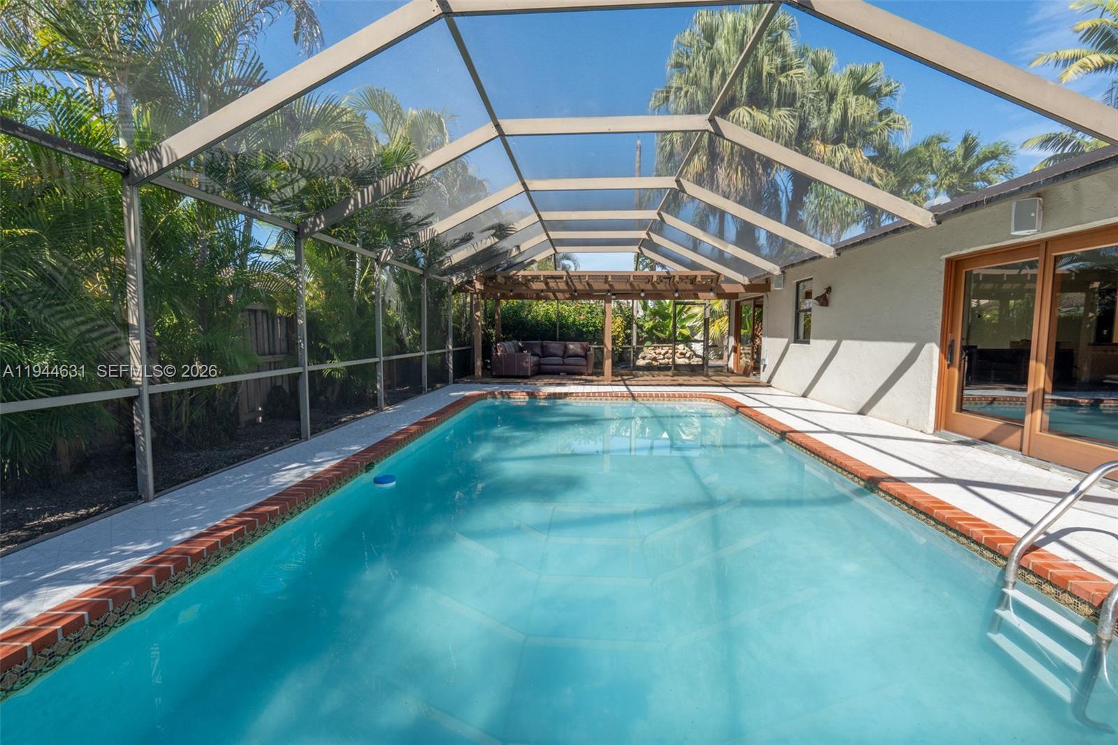 Bright and beautifully maintained pool home in a desirable Kendall neighborhood. Features a huge primary suite with walk-in closet and spacious bath, 3 bedrooms plus open office (easily convertible to 4th bedroom), newer roof (2020), brand-new A/C, and impact doors throughout. Enjoy a private backyard with pool, new screened enclosure, pergola, and lush landscaping. 2-car garage, abundant natural light, and move-in ready.