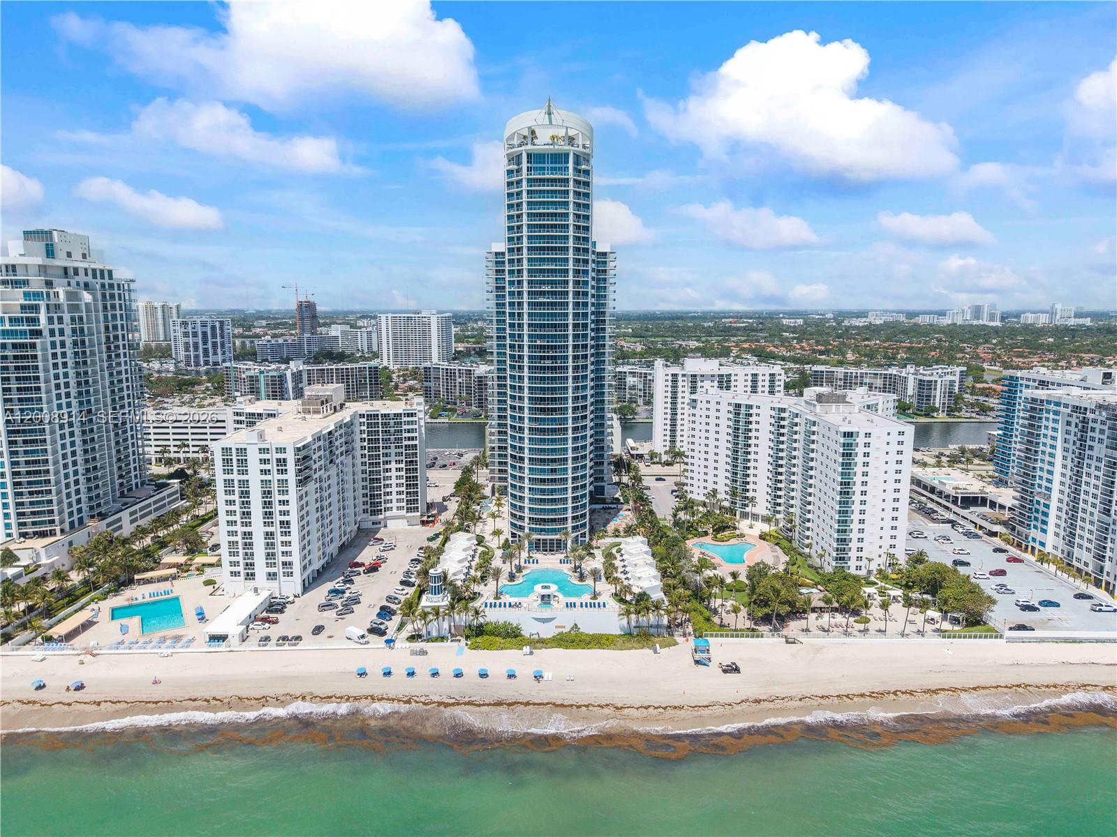 Exceptional opportunity to own in one of Ocean Palms, one of Hollywood’s premier oceanfront buildings. This beautifully designed 3-bedroom, 3.5-bath residence features a spacious layout with en-suite bathrooms in every bedroom plus a separate guest powder room. Enjoy abundant natural light from the north-facing exposure, offering direct views of the Atlantic Ocean and Intracoastal Waterway from every room. The open-concept kitchen flows seamlessly into comfortable living spaces, perfect for both everyday living and entertaining. Residents enjoy first-class amenities, including deeded beach access with chairs and umbrellas, a resort-style pool, and a fully equipped fitness center. Ideally located near shopping, dining, and major highways—schedule your showing today.