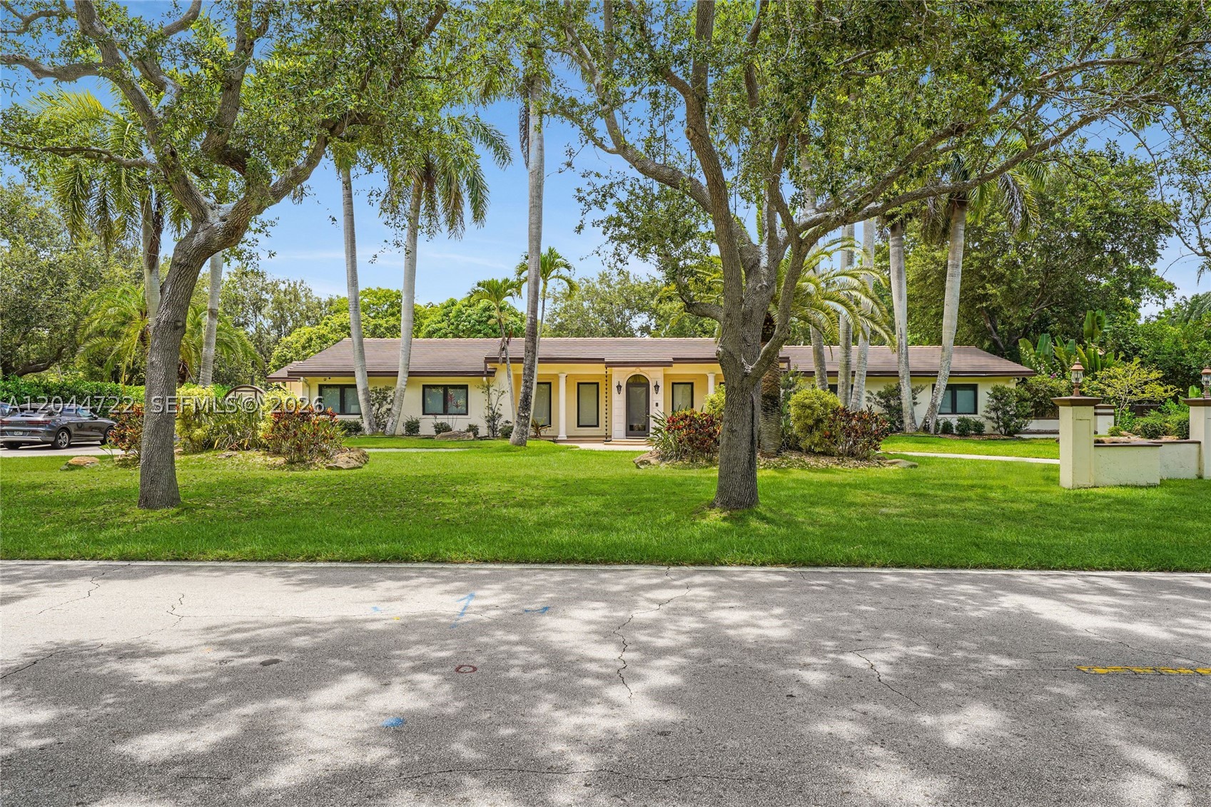 Set on an expansive 36,721 SF lot in one of Pinecrest's most desirable neighborhoods, this gracious single-story residence offers an exceptional blend of space, comfort, and functionality. The 6-bedroom, 4.5-bath floor plan features generous formal and casual living areas, including a formal living room, spacious family room, media room, and a split-bedroom layout designed for privacy. The granite kitchen opens to the home's inviting gathering spaces, while two primary suites provide flexible living arrangements for multigenerational households or long-term guests. Travertine marble floors, impact windows installed in 2023, and a 2016 roof enhance the home's lasting appeal. An office or maid's quarters with a separate entrance offers additional versatility. Outdoors, enjoy a tropical backyard with a pool, covered patio complete with a wet bar, and a circular driveway with ample space for boat parking. Ideally located just minutes from top-rated schools, parks, dining, and everyday conveniences.