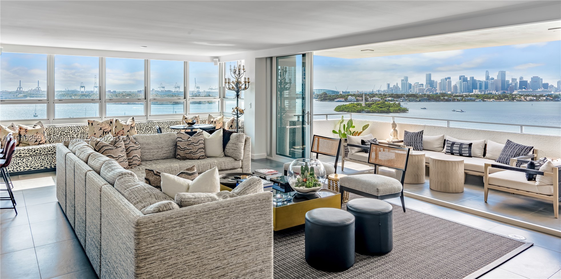 Exquisite corner with sweeping views from South Beach to the dazzling Miami skyline. Originally 2 units, elegantly reimagined into a spacious 4BD/3.5BA residence w/2 terraces. The open concept living area seamlessly combines design & function, anchored by a stunning kitchen featuring Black Marquina marble. The grand primary suite has dual walk-in closets, a luxurious bath, and terrace. Highlights include impact windows & doors, remote-controlled shades, laundry room, & 2 parking spaces. A full-service building offering 24-hour security, a renovated gym, meeting and party rooms, and a rooftop solarium boasting some of the most spectacular views in the city.  Ideally situated and moments from Sunset Harbour to Lincoln Road-an unbeatable central location and an exceptional place to live.