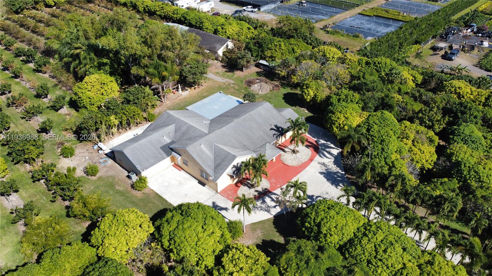 **PRICE IMPROVEMENT!!** Welcome to your private retreat on 4.75 acres! This 4-bedroom, 4-bath home features high ceilings, an open layout, tile floors, blinds, and ceiling fans throughout. The spacious kitchen offers an eat-at island, stainless steel appliances (microwave, stove, refrigerator, dishwasher), and a pantry. Enjoy gatherings in the family room with French doors opening to outdoor living. The home includes a laundry room with washer and dryer, a serene primary suite with dual sinks and tub/shower, plus a flex room/office. Outdoors you’ll find a covered patio, pond, tropical fruit trees (see list attached), an old chicken coop, whole-home water filtration, propane fireplace, generator with tank, AS-IS detached 2-car garage, and carport—perfect for country living with modern comfort. PROOF OF FUNDS AND/OR PRE-APPROVAL LETTER REQUIRED PRIOR TO SCHEDULING A SHOWING OF THE PROPERTY!
