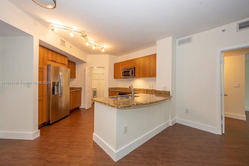 This Magnificent and Impeccable 2 Bedroom, 2 Bathroom + Den Condo is Open and Very Bright. It Boasts Open Floor Plan with Tiled Floors, S/S Appliances and Open Kitchen, Granite Counter, Impact Glass Windows and is in Move-In Condition. Other Amenities Include European Cabinetry-Marble Shower and Soaking Bathtub-Smart Key FOB Entry into Building-Washer and Dryer-Elegantly Appointed Lobby-Resort-Style Tropical Pool and Jacuzzi-24-Hour Manned Security at Front Desk-Dawn to Dusk Roving Security-High-Tech Security System-Fitness Center-Dry Sauna and much more. Internet Access, Cable TV and Running Water is Included and (2) Assigned Parking Spaces in the gated garage.