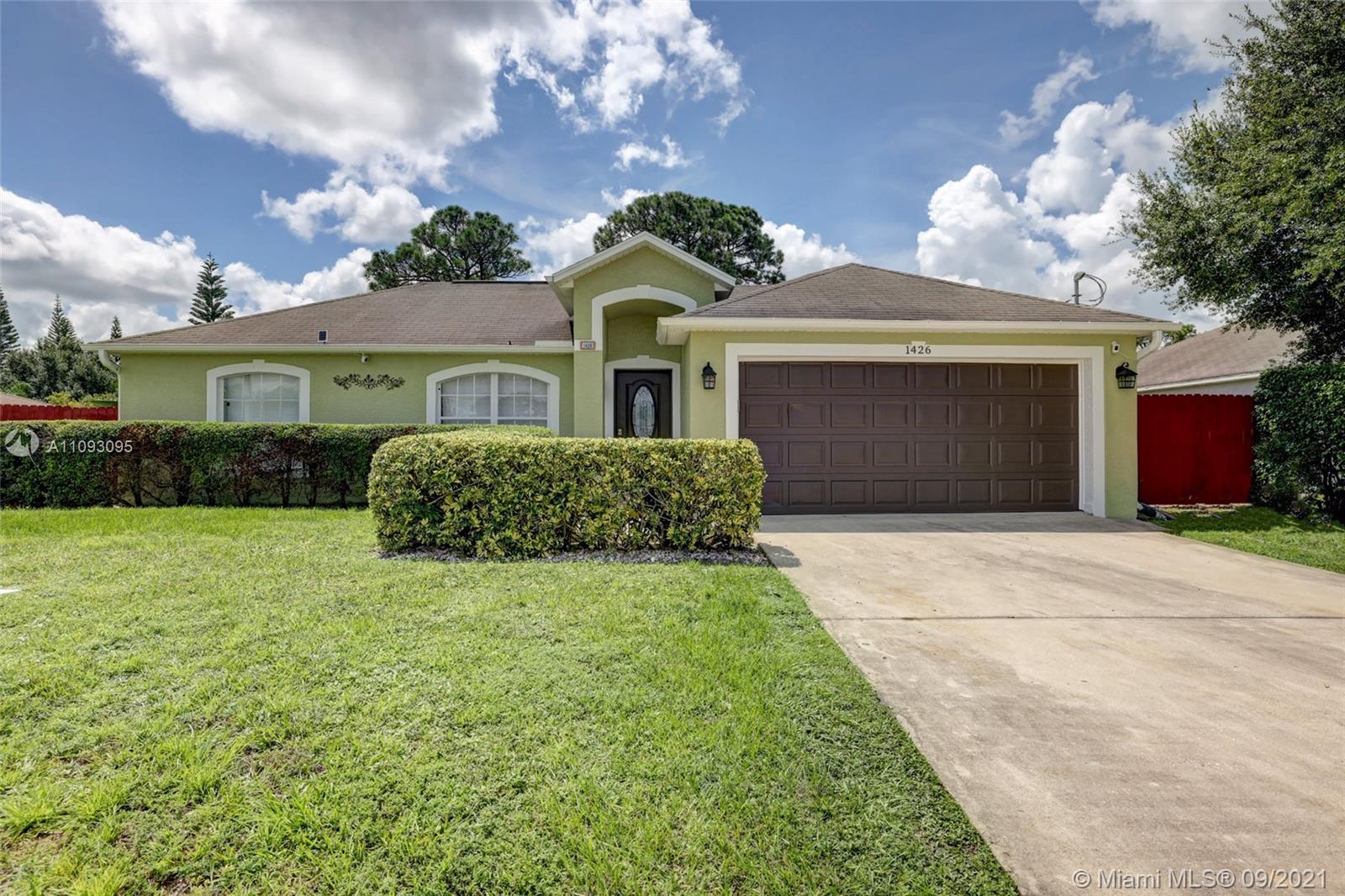 Come see this beautiful gem centrally located in the heart of Port Saint Lucie. The features in this home are endless: 3 spacious bedrooms, 2 bathrooms (one newly remodeled), 2 car garage, new roof installed before closing, an ample split floor plan with an open remodeled island kitchen, stainless steel appliances, new washer and dryer, tile floors throughout, a large family room and high ceilings. Outside you'll find a great outdoor kitchen with a built-in grill and outdoor furniture that stays, fully fenced in yard with enough room for a pool, an outdoor shower and a convenient shed. Close to major highways, shopping and dining.