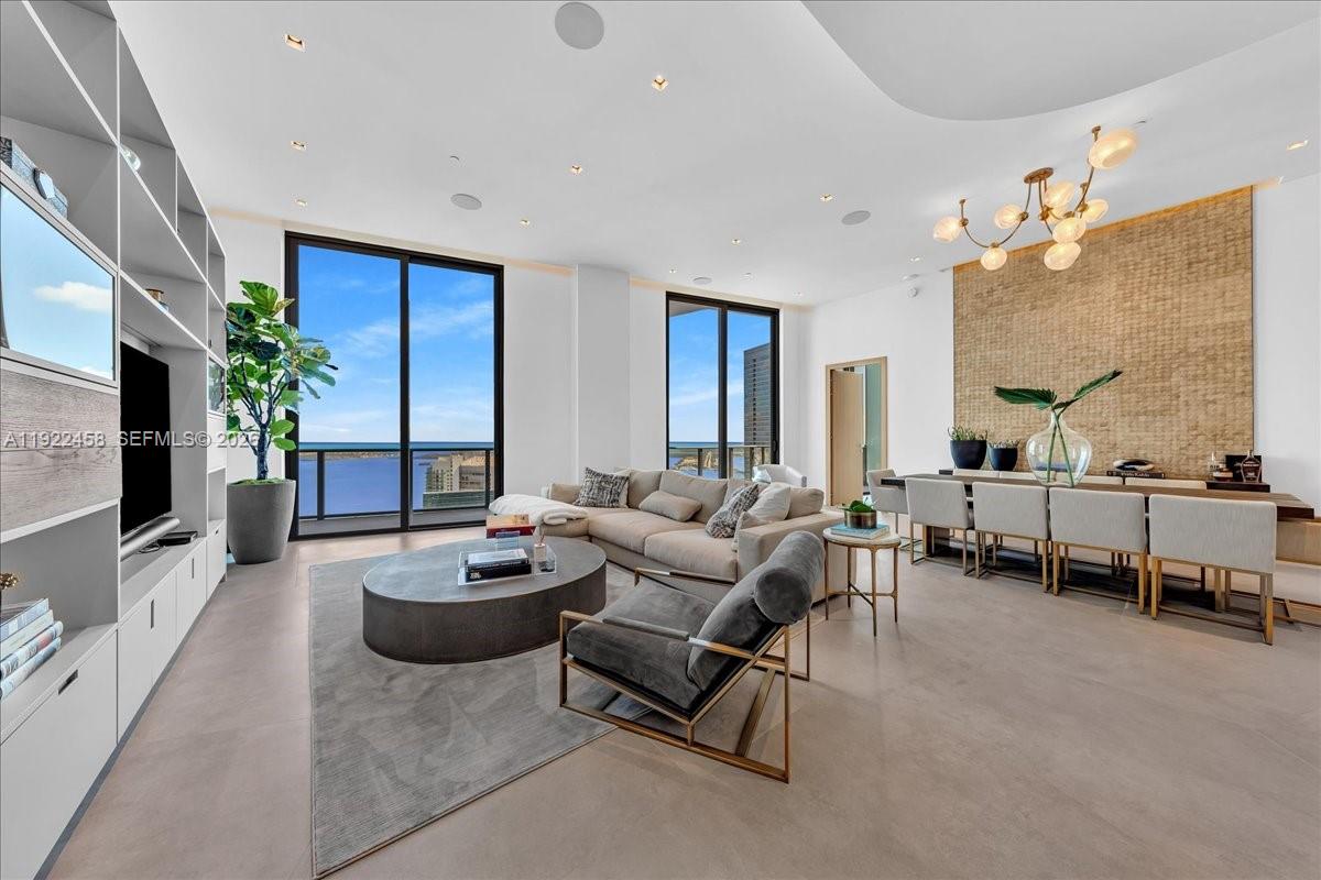 A Rare Jem In The Sky! Absolutely Breathtaking 2-Story Upper Penthouse featuring a Private Rooftop Terrace and Private Plunge Pool / Jacuzzi with Panoramic Water Views. This fully furnished ultra-modern residence spans 4,100 Sq Ft (2,200 interior / 1,910 exterior) and boasts bespoke interiors by renowned Avanzato Design, where every detail reflects refined luxury and thoughtful functionality.  The main level offers soaring vaulted ceilings, imported hexagon flooring, a private movie room (easily convertible to a fourth bedroom), high-end finishes, and a full smart-home system. A custom spiral staircase leads to your private rooftop retreat featuring a jacuzzi, built-in kitchen with electric grill, lounge seating, and stunning skyline and bay views — perfect for entertaining or unwinding in total privacy.  Residents enjoy DUA’s 5-star amenities and a premier Brickell location within steps from fine dining, luxury shopping, and scenic bayfront walks. A Rare Jem In The Sky!