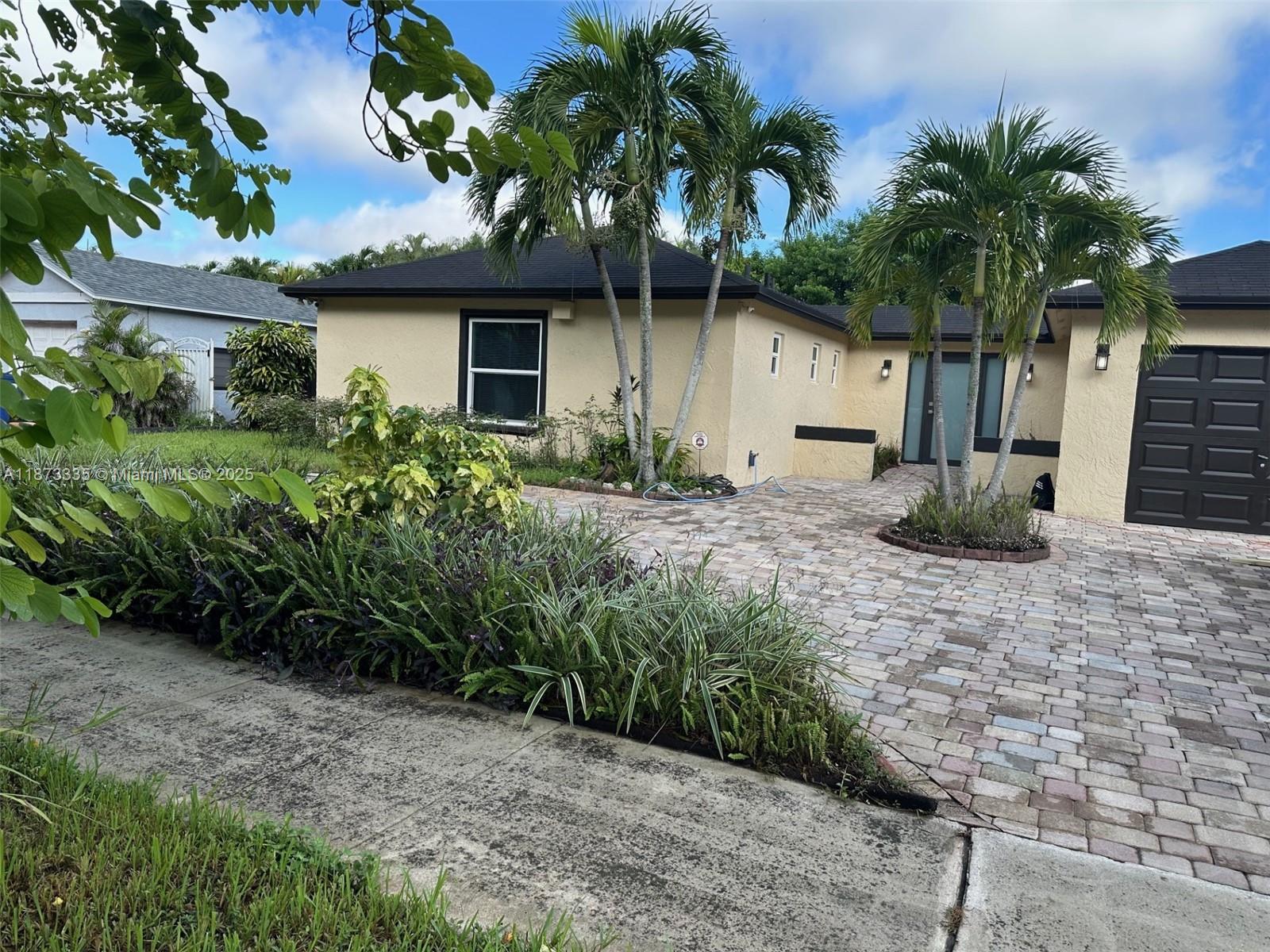 Modern 3-Bedroom, 3-Bath Home in prime Miami-Dade County location. Located near Miami Lakes and Miami Gardens, this move-in-ready gem features, Polished Porcelain tile flooring throughout. Updated kitchen with premium Samsung appliances, including Double oven range, and 4-door refrigerator. Master bath with Jacuzzi tub. Impact windows and doors for safety and energy efficiency. One-car garage. Covered terrace. Landscaped patio with mango, avocado and bananas trees. Patio with room to add a pool. This home blends style, comfort, and functionality—perfect for families or entertainers alike.