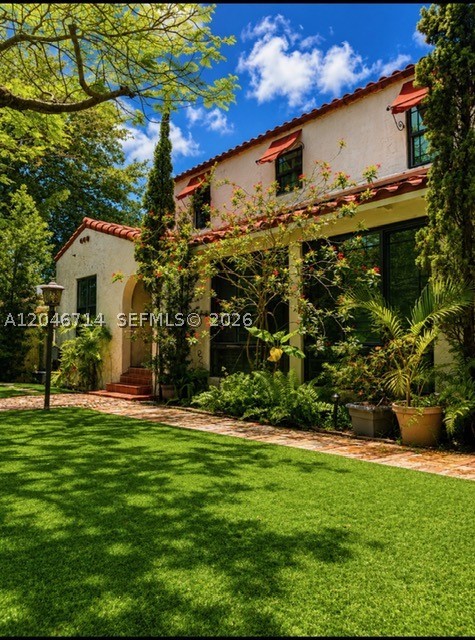 Blending timeless Spanish-inspired architecture with thoughtfully curated modern updates, this exceptional two-story residence offers comfort, style, and functionality on an expansive 15,000± sq. ft. lot. 2018 ROOF AND 2917 AC! IMPACT WINDOWS AND DOORS! A private walled entry and detached 2-car garage create a secluded retreat, while the home's classic character shines through with hardwood floors, exposed wood beams, and a fireplace. The renovated kitchen serves as the heart of the home, complemented by recessed lighting. Energy efficiency and peace of mind come standard with owned solar panels and two Tesla Powerwall batteries, providing backup power during outages. Step outside to a spacious backyard designed for effortless entertaining. Enjoy a fully equipped outdoor kitchen featuring a built-in grill, sink, and refrigerator. Cabana Bathroom! The custom pool and spa become the centerpiece after sunset with elegant lighting that transforms the space into a true backyard oasis.