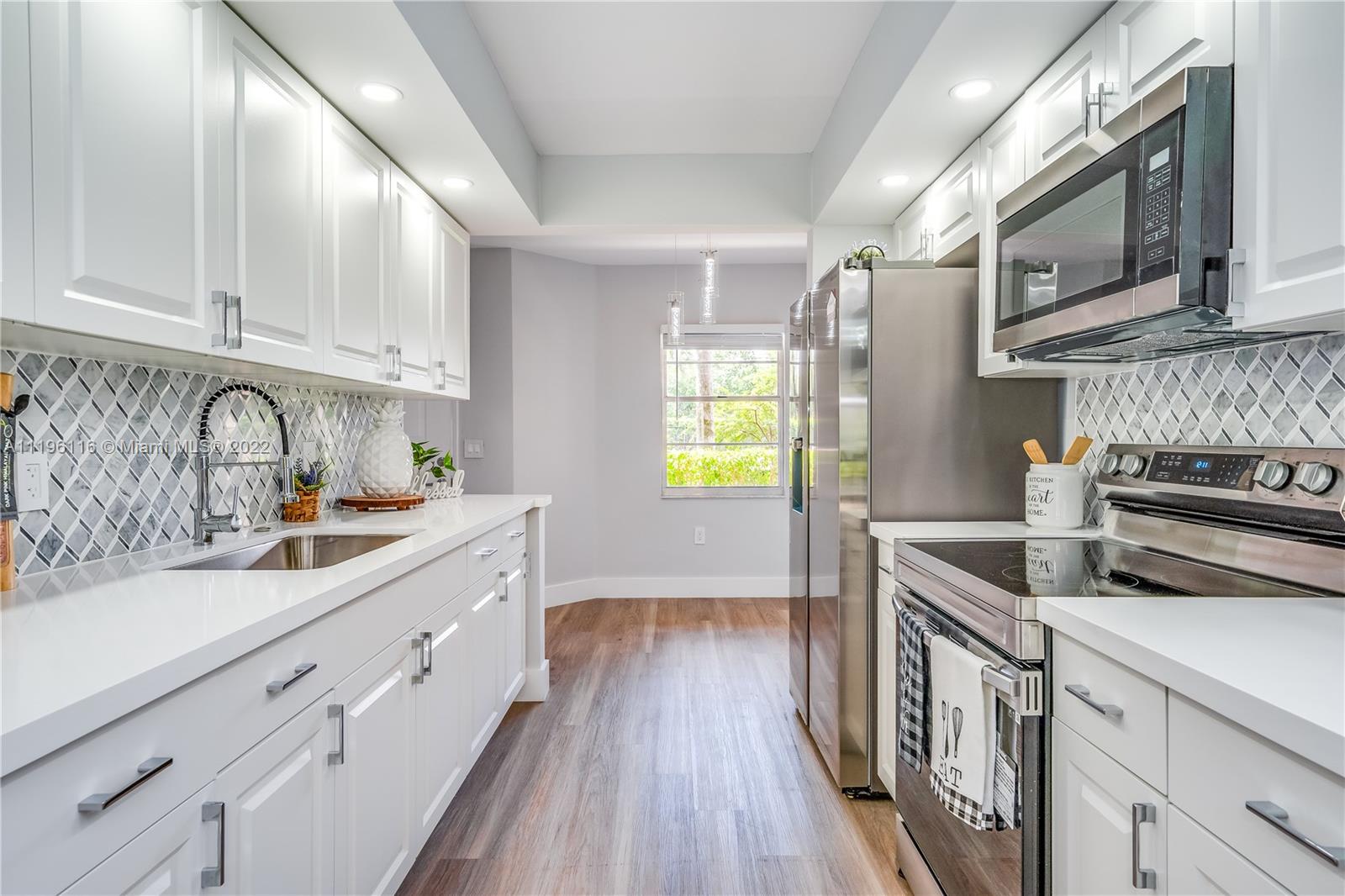 Welcome to this Gorgeous & Bright 2/2 completely remodeled 1st floor condo located in the heart of Pembroke Pines. Features a brand new kitchen w/top-of-the-line SS appliances & modern cabinets & countertop, brand new AC & tankless water heater. Large master bedroom w/walk-in closet. Both bathrooms are completely renovated. Beautiful brand new vinyl floors & LED lights throughout the unit. Freshly painted. Washer & dryer inside the unit; assigned parking & plenty of guest parking. HOA is $526.89 includes water, cable, internet, w/endless amenities a million-dollar clubhouse. This unit is located in Ivanhoe East III at Century Village, one of Pembroke Pines’ most desirable active adult communities. 55+. Located next to the shop of Pembroke Gardens and major highways. Schedule a Showing now!