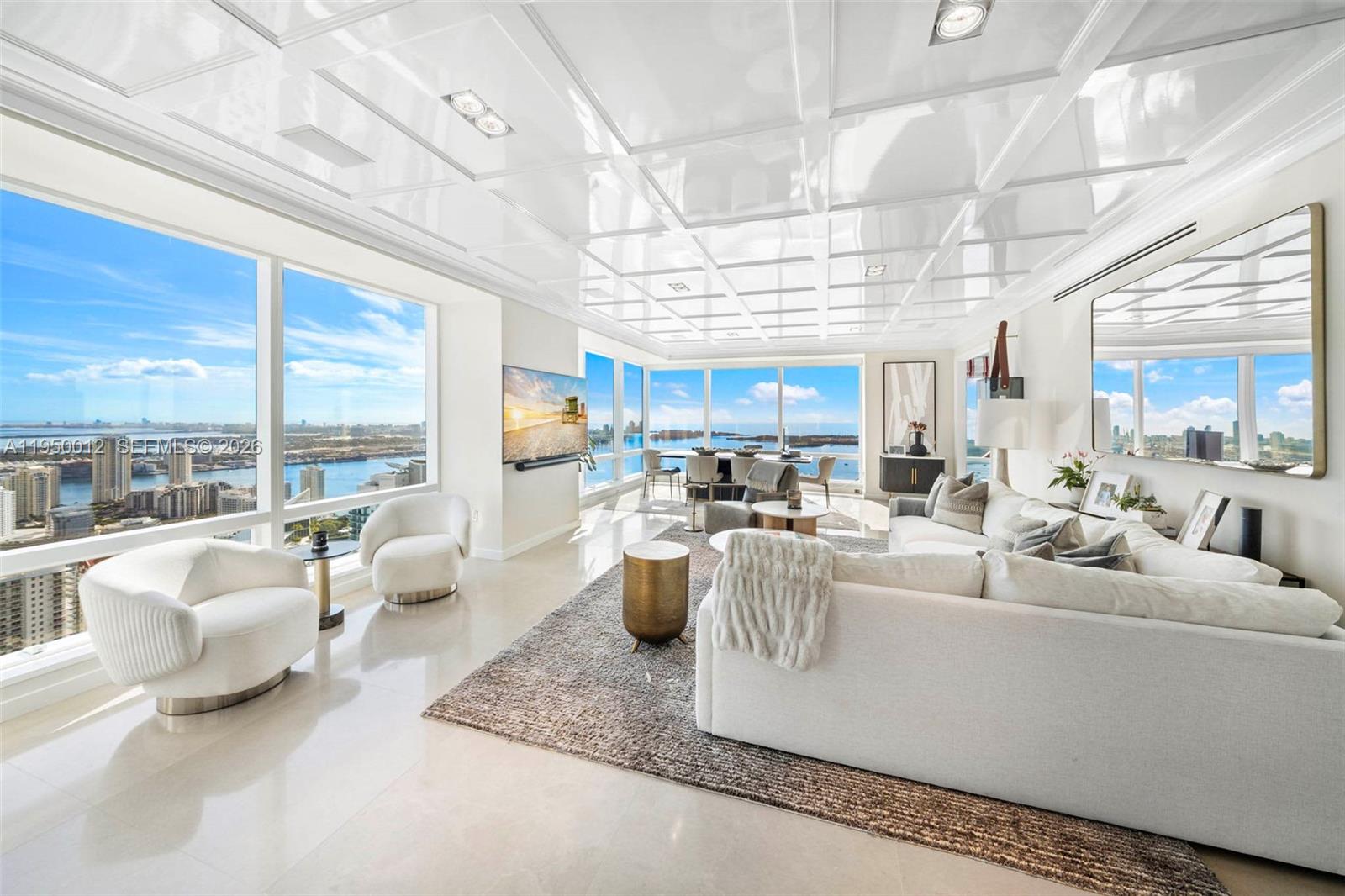 Experience unrivaled sophistication in this exceptional 3,357 square foot corner residence at the iconic Four Seasons Brickell, soaring above the city on the 58th floor. This exquisitely appointed 3-bedroom plus den, 4-bathroom home showcases sweeping panoramic views and a seamless blend of timeless elegance and modern comfort. Rich wood and marble floors flow throughout expansive open living spaces, illuminated by floor-to-ceiling glass that frames the skyline and bay beyond. Each bedroom is a serene private retreat with spa-inspired en-suite bathrooms and generous closet space. The chef’s kitchen is thoughtfully designed with top-of-the-line appliances and sleek refined finishes ideal for both intimate dining and entertaining. Residents enjoy access to an expansive 2-acre sun deck with lush landscaping, hammock gardens, a heated swimming pool, kids’ pool, whirlpool, lounge seating and poolside dining. Additional amenities include two on-site restaurants, a boutique, business center, 15,000 square feet of event space and a 50,000 square foot Equinox fitness club offering group classes, personal training and a full-service spa with a wide range of health and beauty treatments. Four Seasons services include personalized concierge, 24-hour in-room dining, valet parking, security, housekeeping, laundry and dry-cleaning services and curated activities for children.