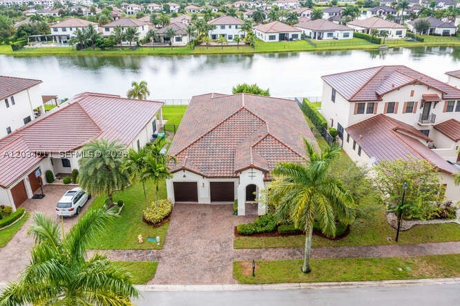 Lakefront "Brisbane" model home located in Vista del Sol in Monterra one of Cooper City's most desirable communities. This single-story home is situated on a premium lot and features: 4 bedrooms, 3 bathrooms, 2 car garage and a versatile den (ideal for a media room, gym, or playroom). Impact windows throughout, stainless steel appliances built in oven & microwave, refrigerator, cooktop... Access to excellent A+ rated schools. Clubhouse with Spacious Grand Lobby, State-of-the-Art Fitness Center, Aerobics Studio, Banquet Room with Prep Kitchen, Play Room, Expansive Loggia, Resort-style Swimming Pool, Splash Pad, Tot Lots/Playgrounds, Basketball Courts. Cycling and Walking Trails, Lakes and Nature Preserves...