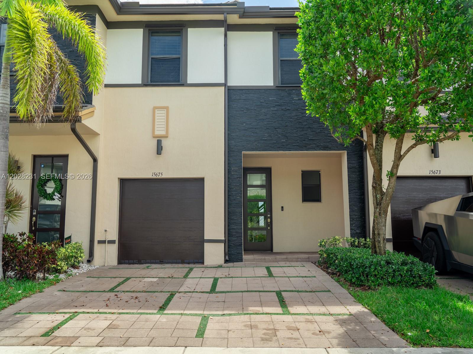 Beautiful waterfront townhouse located in the highly desirable gated community of Satori in Miami Lakes. This spacious 3 bedroom, 2.5 bath residence offers 1,743 SF of living space featuring an open-concept layout, modern kitchen with stainless steel appliances, large center island, contemporary cabinetry, and abundant natural light throughout. The first floor features oversized tile flooring, while the second floor offers updated laminate flooring and spacious bedrooms. Enjoy relaxing lake views from the private patio with no rear neighbors. Additional features include a one-car garage, two-car driveway, full-size washer and dryer, and access to resort-style amenities including a clubhouse, pool, fitness center, playground, and 24-hour guard-gated entry. Conveniently located near shopping, dining, major highways, and top-rated schools. Move-in ready.