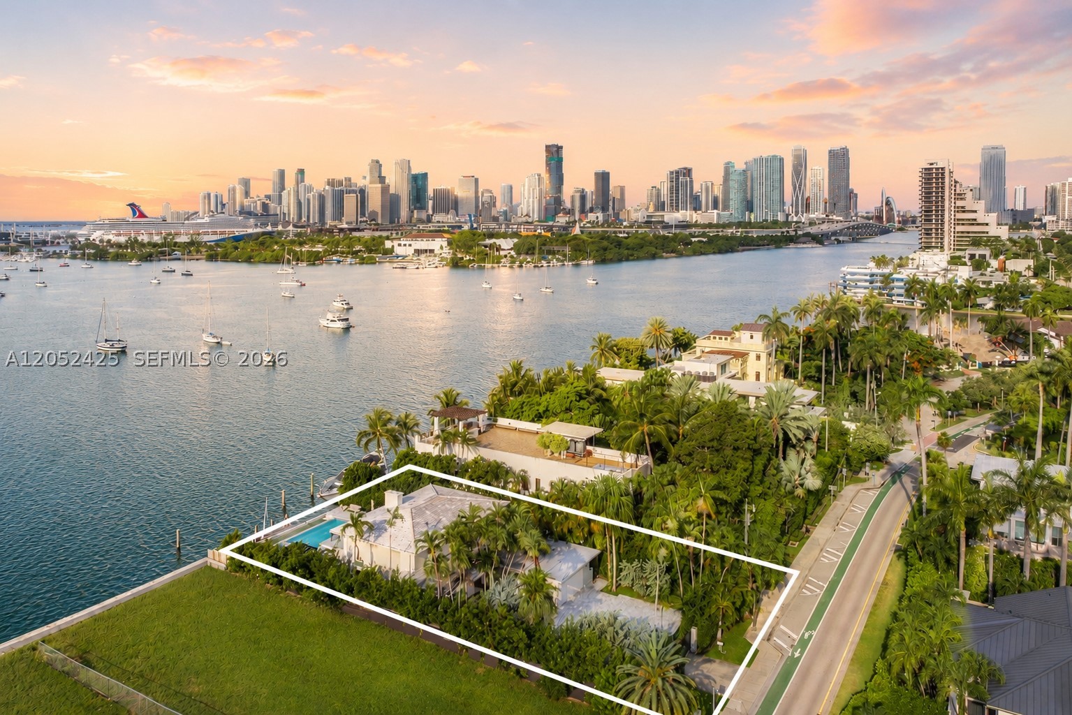 Experience exceptional waterfront living on the coveted Venetian Islands with breathtaking open Biscayne Bay and downtown Miami skyline views. Set on a 12,250 SF south-facing lot with 70 feet of waterfront, a private dock, and direct bay access, this residence is ideal for boating enthusiasts. Walls of glass frame the spectacular views while creating a seamless connection between the indoor and outdoor living spaces. The open floor plan features oak plank wood and tile flooring, a spacious living area with a built-in bar, and a chef's eat-in kitchen appointed with Wolf appliances and marble countertops. The private primary suite serves as a tranquil retreat with a spa-inspired bath and an expansive waterfront balcony overlooking the infinity-edge pool. Designed for effortless entertaining, the outdoor living spaces include a summer kitchen, generous lounge areas, and stunning panoramic bay views. A rare opportunity to enjoy the best of Miami waterfront living just minutes from Sunset Harbour, Downtown Miami, and the beaches.