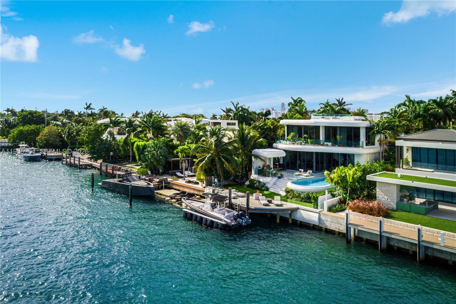 Built in 2018 & designed by DOMO Architecture, this extraordinary waterfront estate stands as the tallest residence on Dilido Island, offering architectural distinction, privacy & uncompromising luxury. Conceived for grand-scale entertaining, the home features executive-level security & soaring 12 foot ceilings with a fully integrated smart-home system. An exceptional use of luxurious marble throughout the interior & exterior creates a timeless, gallery-like elegance. The state-of-the-art kitchen, finished in striking Calacatta Gold marble & equipped with Wolf, Miele, & Sub-Zero appliances, anchors the home as a natural gathering space. Living areas flow seamlessly outdoors, embracing indoor-outdoor living with a resort-style pool, Jacuzzi, cabana, & a custom extra-large rounded Ipe dock, ideal for waterfront entertaining. Private bedroom suites embody modern luxury, featuring warm chevron oak floors, floor-to-ceiling sheer drapery, refined marble details, & Waterworks faucets and shower fixtures throughout. A dedicated cinema room with an 8K 125-inch projection screen & THX surround sound delivers a true private theater experience. Crowning the residence is a spectacular rooftop retreat with 360-degree water views of Downtown Miami and Miami Beach, complete with an award winning fully edible rooftop garden/farm. Additional features include a showroom garage (lift capable) & mature fruit & vegetable trees, completing this one-of-a-kind waterfront offering.