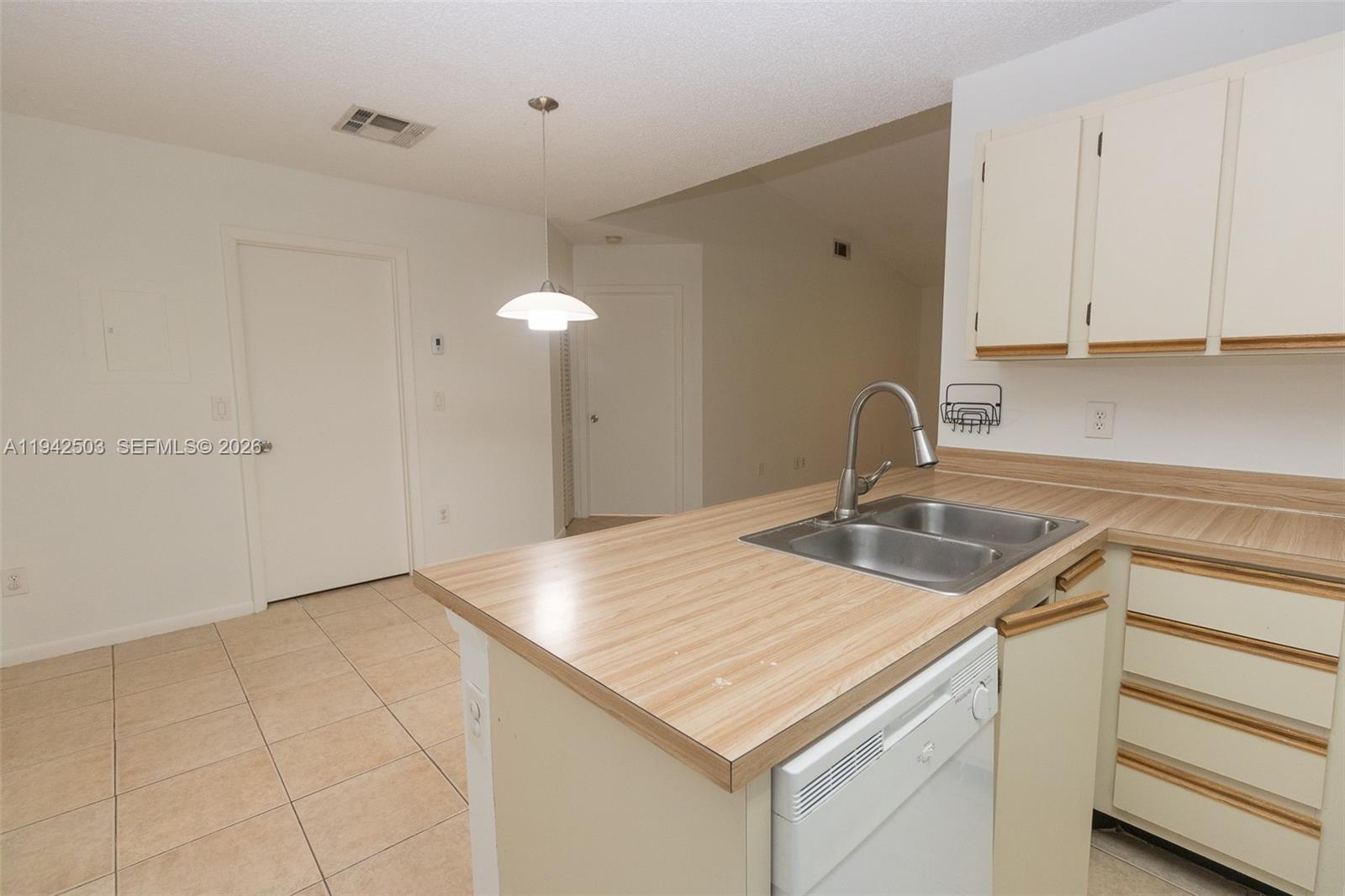 Experience luxury living in this stunning 1-bedroom, 1-bathroom condo located within the secure, family-friendly gated community of La Hacienda. This second-floor residence boasts vaulted ceilings and tile flooring throughout, complemented by modern light fixtures and an open-concept kitchen with newer appliances. For your convenience, the unit includes an in-home washer and dryer and one assigned parking space. Residents enjoy premium amenities including a swimming pool, clubhouse, and gym, all protected by 24/7 security. Perfectly situated for commuters, you'll have rapid access to the 826, I-95, and I-75, and find yourself just minutes away from top-tier shopping, dining, and healthcare.