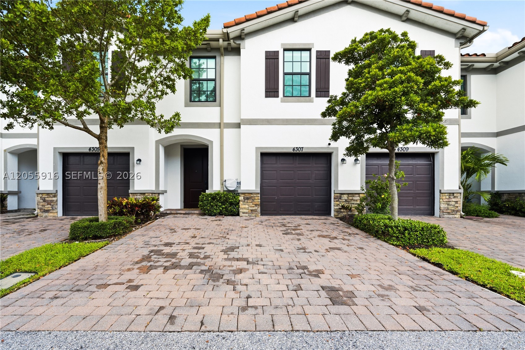 Fully furnished, ultra-modern and upgraded from top to bottom! This exceptional 4-bedroom, 2.5-bath townhome in the gated Arbor Parc community offers sophisticated, turnkey living ideal for those relocating to Palm Beach County or seeking a beautifully furnished annual residence. Nearly every detail has been elevated with high-end finishes, including glossy tile flooring throughout, fresh interior paint, upgraded solid doors and casings, contemporary lighting and recessed LEDs with adjustable tones. The modern kitchen features upgraded cabinetry and fixtures plus a smart Samsung refrigerator. Enjoy custom built-out closets, a smart washer and dryer, tiled garage with ceiling-mounted storage, wall-mounted TVs, electric blackout blinds, smart locks and Google Home camera setup. Impact-rated windows and doors add convenience, while the private fenced backyard with turf and extended patio pavers creates a stylish, low-maintenance outdoor retreat. Ideally positioned for easy access to I-95, Palm Beach International Airport, Palm Beach Gardens and West Palm Beach, with convenient proximity to area private schools, business centers, shopping and dining. Move in, unpack and immediately enjoy elevated South Florida living.