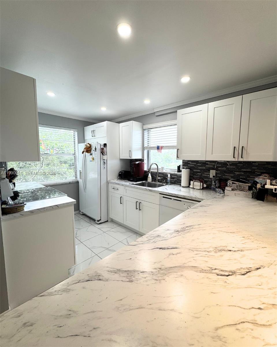 Nestled in the lush, gated Las Vistas community, this corner unit is completely remodeled 2-bedroom, 2-bathroom retreat that offers style, comfort and peace of mind. Has a bright, open-concept modern kitchen. Both bedrooms are generously sized the primary suite boasts a large walk-in closet and a spa-like en suite bathroom with frameless glass shower and dual vanity, while the second bedroom sits steps from a full second bathroom finished with contemporary fixtures and stylish tile. Enjoy year-round comfort with central AC, and revel in the updated finishes Outside your front door, Las Vistas offers a sparkling pool, clubhouse, and fitness center. Located minutes from dining, shopping & Inverrary’s recreational amenities, this turnkey gem perfectly blends modern elegance & community living. Home Warranty will be transferrable. No Special Assessments. 650 minimum credit score required.