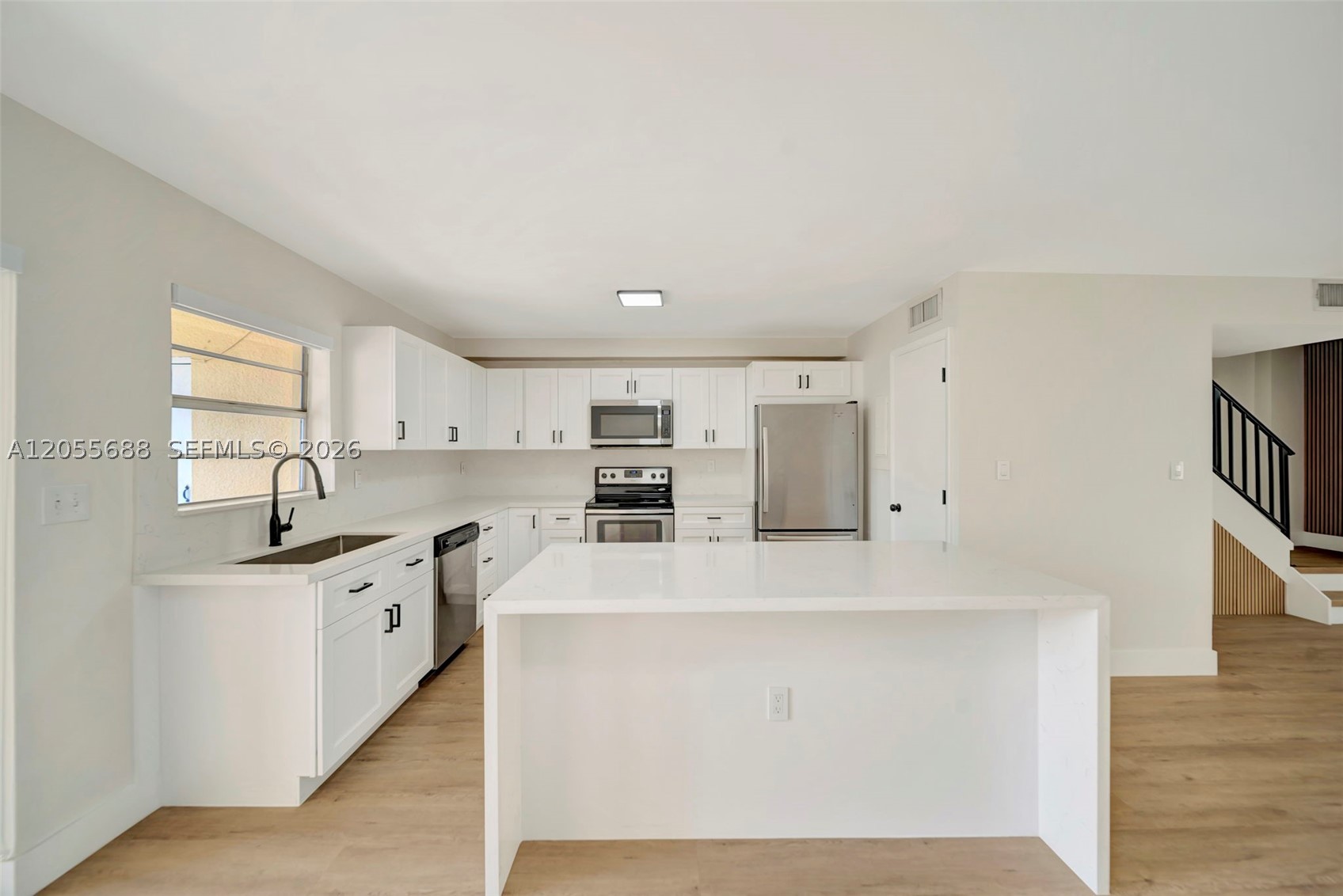 Fully remodeled from top to bottom, this stunning home offers the perfect blend of modern luxury and thoughtful design throughout. The show-stopping kitchen boasts elegant quartz countertops, a dramatic quartz waterfall island, and an oversized walk-in pantry that's as functional as it is impressive. Brand new commercial grade luxury vinyl flooring flows seamlessly throughout, complemented by fresh interior paint and contemporary black fixtures and hardware that create a sophisticated, designer-inspired look. Every bathroom has been beautifully reimagined with sleek floating vanities and LED illuminated mirrors, delivering a spa-like ambiance. Every detail of this exceptional renovation was thoughtfully selected, making this truly move-in ready home a rare offering that stands out from the rest. Centrally located in the heart of Kendall off 137 Ave and Kendall drive you are walking distance to everything.