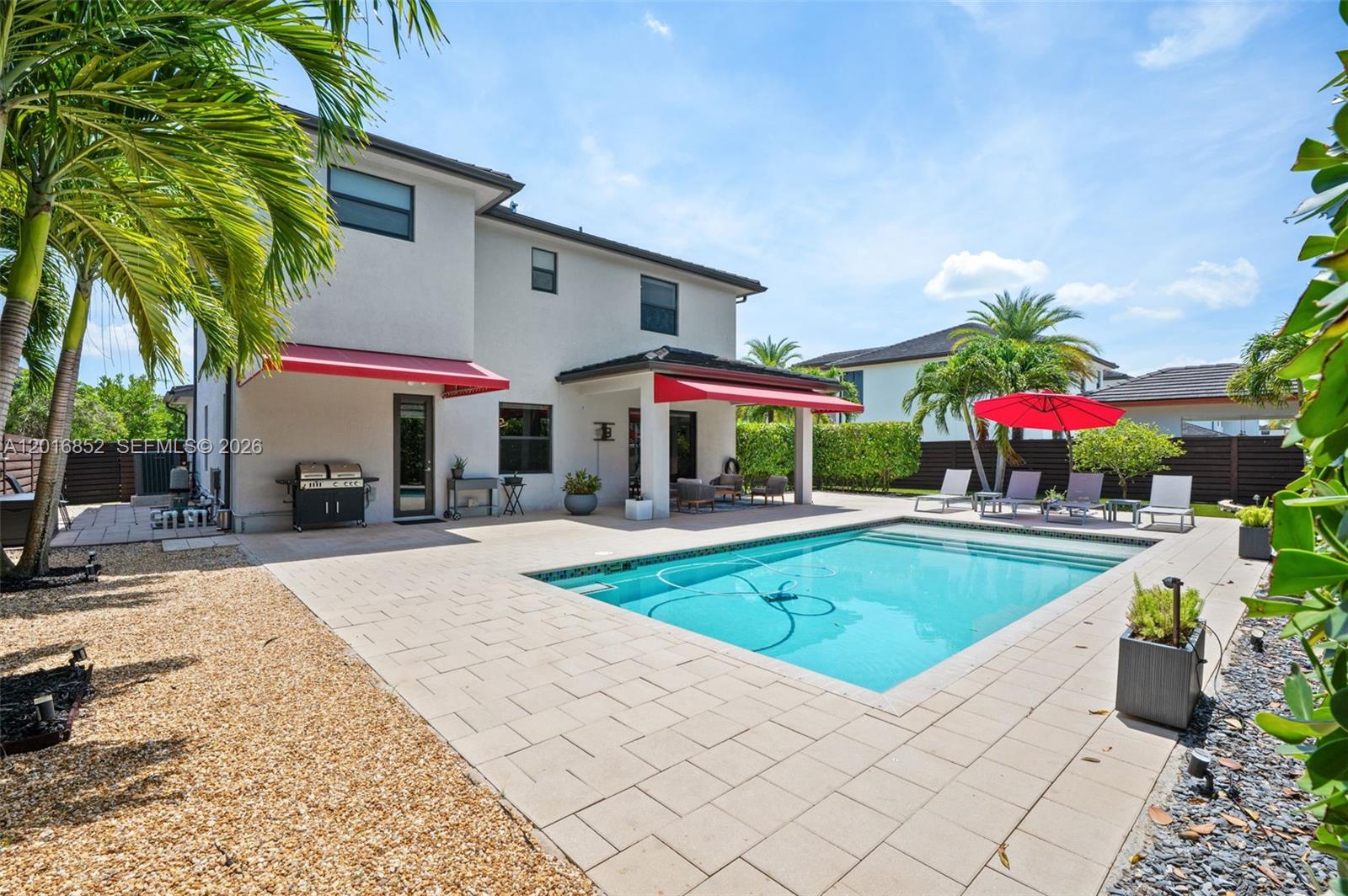 Experience elevated living in the prestigious guard gated community of Satori in Miami Lakes. Situated on a rare oversized 8,711 SqFt Presidential Lot, nearly 70% larger than the average homesite in the community, this exceptional 4 bedroom, 3 bathroom residence offers 2,847 SqFt under AC with a perfect blend of luxury, style, and sophistication. The highly desirable layout includes a full bedroom and bathroom on the ground floor. Soaring 20 foot ceilings create a dramatic first impression, while complete impact windows and doors, designer lighting, porcelain wood look tile upstairs, and a beautifully remodeled primary bathroom showcase thoughtful upgrades throughout. Step into your private resort style backyard featuring a sparkling saltwater pool with sun shelf and lush fresh landscaping designed for both relaxation and entertaining. A truly rare offering in one of Miami Lakes’ most sought after communities.