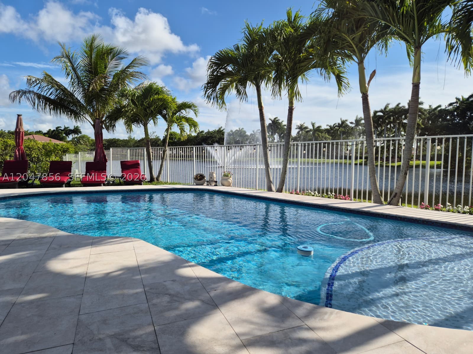 Stunning 1-story lakefront 5BR/3BA pool home in Weston's exclusive gated community, The Ridges! Walking distance to top-rated schools. Modern light-filled interior w/ soaring high ceilings, stainless steel appliances & sleek contemporary finishes. Private backyard oasis w/ pool overlooking a serene lake with a picturesque fountain view. 2-car garage plus driveway parking for up to 3 additional vehicles. Resort-style amenities incl. clubhouse, community pool, tennis & sand volleyball courts, plus park-like grounds perfect for jogging & outdoor activities. A rare blend of luxury, comfort & unbeatable location — won't last!