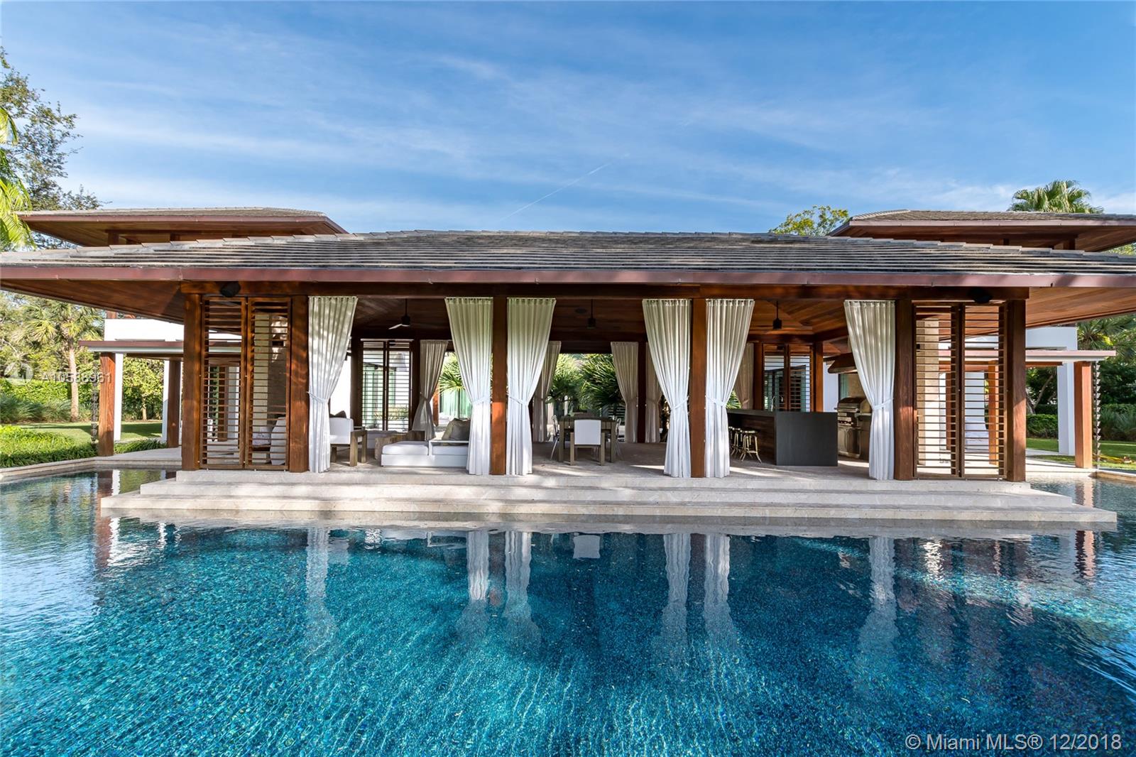 Gables Estates at its finest,this home designed by renowned architect Cesar Molina sits on 2 acres of land & brings paradise to your backyard.This completely smart home w surround sound throughout offers 17,215 SF with wood flooring as well as 6 car garage, 6 bdrms + office & media room + 9.2 bthrms.1st floor features formal & informal living room + office,guest suite,media room & top of line chef’s kitchen w Calacatta marble & luxury appliances Subzero & Wolf.Take elevator or floating staircase up to 2nd floor offering 3 bedrms + master suite w his & hers closets and stunning bthrm.Backyard is built for entertaining with summer kitchen,pool & large covered area.Home features full house generator, car wash station & separate structure w full bath for gym/spa w stunning views of backyard.