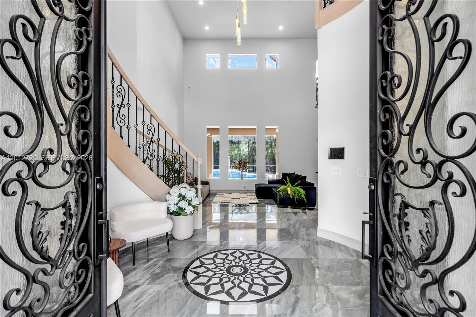 Stunning Estate in Prestigious Heron Bay–Old Brooke Community! Welcome to this exceptional 6BDR, 5BA+Office+Recreation Room+Den, 3 car garage on the largest lot. This expanded Marshbrook model has been completely remodeled w/high-end finishes throughout. Step into an impressive grand foyer w/soaring 20+ft ceilings, a dramatic winding staircase w/custom iron railings, an elegant statement chandelier that sets the tone for this luxurious modern home. *Brand new metal roof-2026*Brand new designer Italian kitchen w/premium new appliances, 66 inch fridge, quartz waterfall island*Fully renovated bathrooms* Downstairs, the expansive primary suite offers a spa-inspired bath with the freestanding tub, direct access to the backyard, while a private guest suite with its own en-suite bath, a dedicated office, an additional full bathroom provide both comfort and flexibility. Upstairs, 4 spacious bedrooms, 2 full bathrooms, a large den, an oversized recreation/media room perfect for the family. The outdoor space is a private screened resort-style oasis featuring a sparkling pool and spa, a fully equipped summer kitchen, built-in BBQ, wine cooler, cocktail bar, brand new heater, salt system, iAquaLink—ideal for hosting or relaxing in total privacy. Enjoy world-class amenities, three 24-hour guard-gated entrances, 2 resort-style clubhouses w/pools, state-of-the-art fitness centers, saunas, premier tennis/pickleball complex, basketball/volleyball courts, children’s water park, café. A+schools