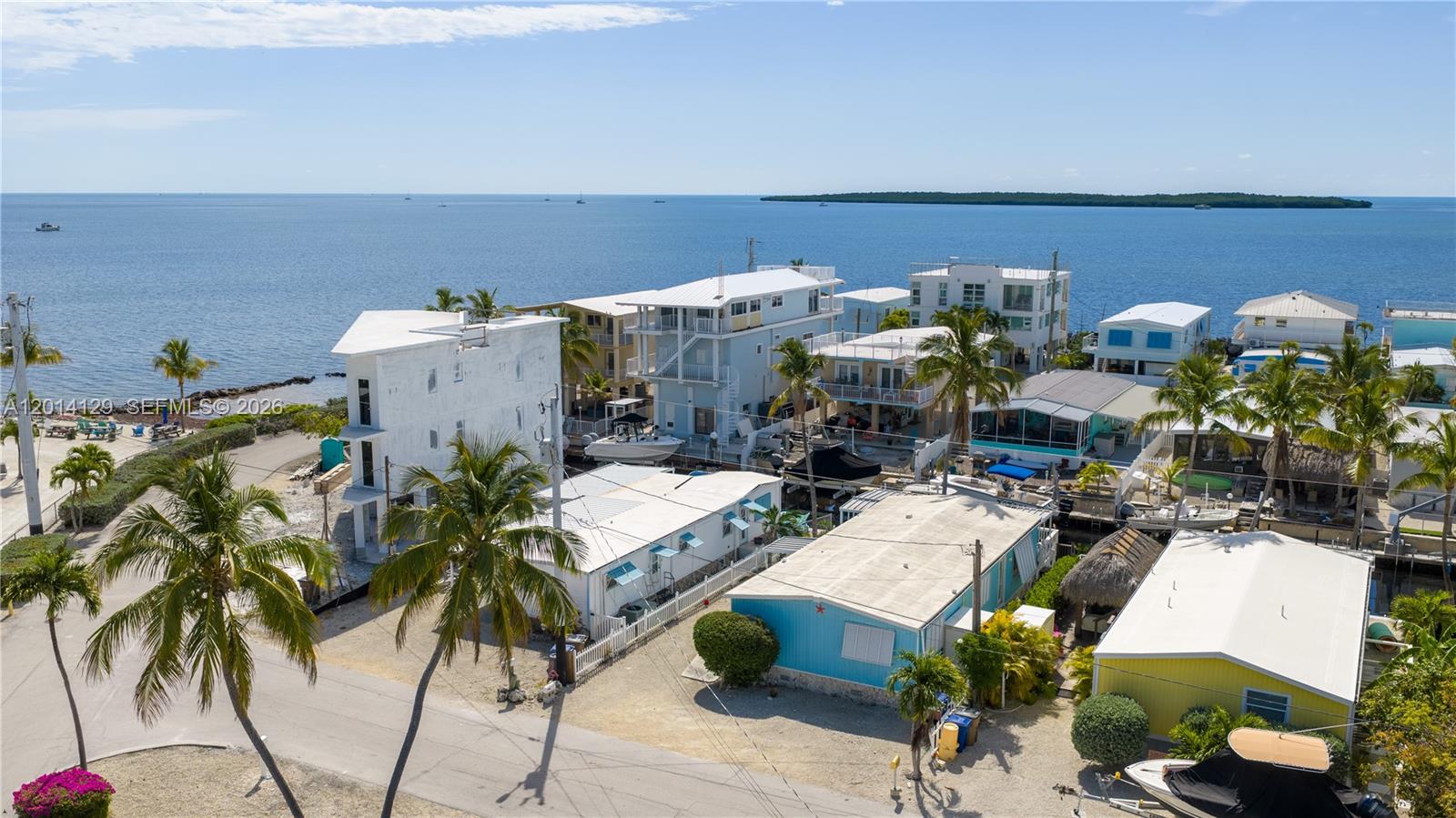 SELLER SAYS "MAKE AN OFFER" Ocean views and direct ocean access! Here's your chance to own an oceanside property in Key Largo with over 44ft of concrete dockage on a beautiful, clean canal in Key Largo's well desired Wynken Blynken & Nod subdivision. The spacious double wide has been thoughtfully updated with tile floors, an open kitchen, large bedrooms with tons of closet space and two fully updated baths. Light and bright with eastern exposure, there are lots of windows and a large covered patio to enjoy sunrises over the Atlantic and breezy afternoons in the shade. Keep your boat high and dry on the 15,000lb boat lift, lower it down and you will be offshore on Key Largo's famous reefs and wrecks in minutes! There is a private homeowner's boat ramp for the exclusive use of neighborhood residents as well. Ideally located at mm96 in Key Largo for easy access to all the fishing, diving, dining, shopping, breweries and galleries the Upper Keys are known for. Enjoy the beauty of Key Largo living now and later you have the option of redeveloping at anytime with no waiting for ROGO - all while keeping those spectacular ocean views!