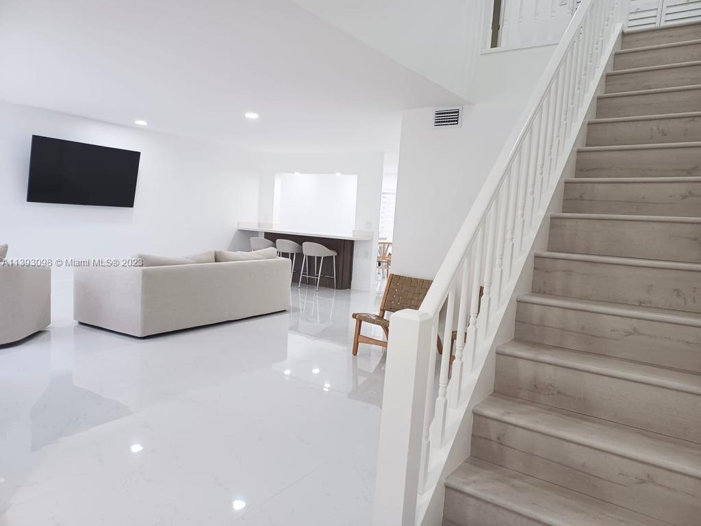 Modern, clean, 3 bedroom 2.5 bathroom  TH located in desirable gated community of Valencia Townhouses. Largest model,  2-story town-house features: 32x32 porcelain tile floors, wood vinyl floors, renovated kitchen, quartz counter tops, stainless steel appliances, washer & dryer, renovated bathrooms, sky lights throughout, smooth ceilings, zebra blinds, 1 car garage, accordion shutters, and a screened in patio. This prim community includes a pool, clubhouse, manicured landscaping, and plenty of guest parking. Roof is 6 years old. Conveniently located near main roads, accessible to FL turnpike, A+ schools, recreational parks, restaurants, shops and entertainment. Low monthly H.O.A. fee!