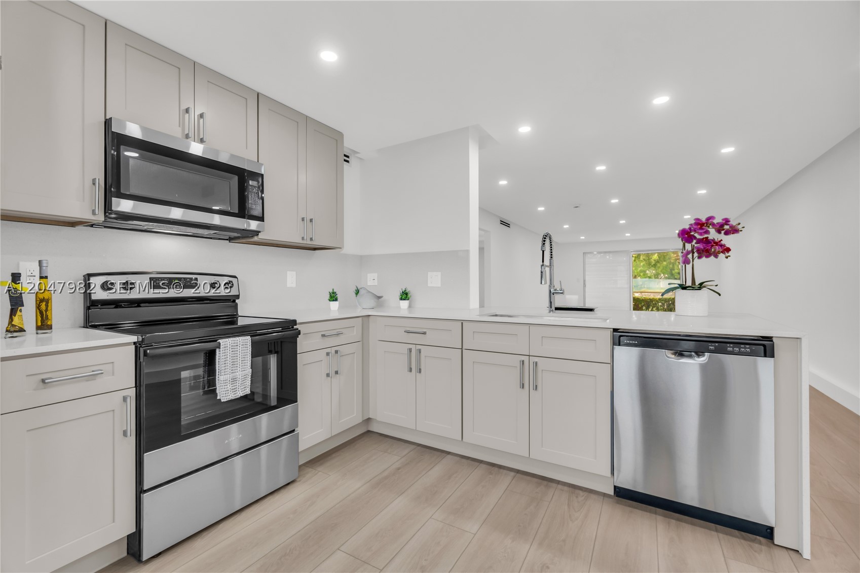 Completely remodeled 2-bedroom, 2-bathroom condo with beautiful lake views! This light-filled apartment features an open-concept floor plan, a stunning kitchen with stainless steel appliances, and modern finishes throughout. Enjoy smooth ceilings with no popcorn, recessed lighting, and contemporary flooring. Both bathrooms have been fully renovated with brand-new walk-in showers, while the spacious primary suite offers a double-sink vanity for added convenience. Relax on your private patio overlooking the lake and enjoy the perfect combination of style, comfort, and functionality. Move-in ready! Located in a desirable 55+ resort-style community offering exceptional amenities, including pools, clubhouse, fitness center, golf, tennis, pickleball, theater, courtesy transportation, and countless social activities. A must-see!