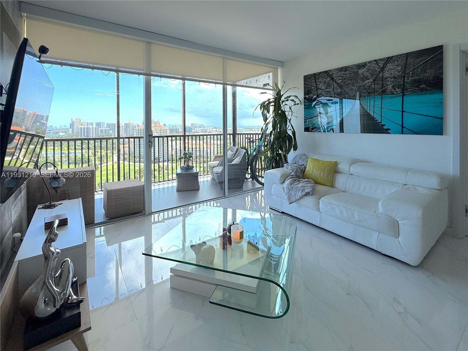 Fully renovated condo with modern finishes and a bright open layout. Enjoy peaceful golf course views from a spacious balcony, plus complete shutter installation for added protection. The building offers resort-style amenities: heated pool with cabanas, fitness center, billiards, library, and 24-hour security. Recently renovated lobby with contemporary touches. Prime Aventura location near shopping, dining, and the walking path.