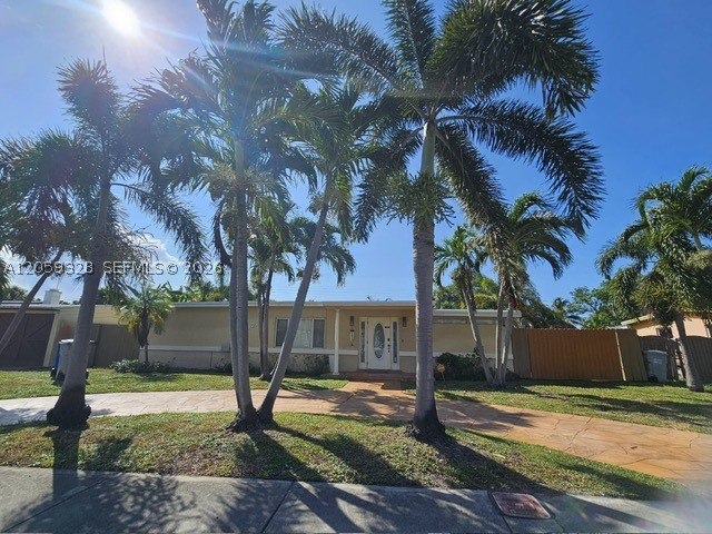 Charming 2bd/2bth, move-in ready single-family home in Pompano Beach Highlands with great curb appeal. Home has hardwood flooring throughout that flows through the main living space, kitchen, and both bedrooms, with a cozy carpeted living room just off the entry. The open layout features vaulted ceilings and a bright kitchen with granite counters and stainless steel appliances. Both bedrooms offer generous space. The master suite includes a large walk-in closet with custom built-in shelving and drawers. The second bedroom is spacious with its own closet and easy access to the second full bath. Step outside to your private backyard oasis featuring an in-ground jacuzzi and a versatile storage shed great for a workshop, gym, studio, or extra storage. The home is fully fenced for privacy. Minutes from the beach, shopping, and major highways...this one won't last!