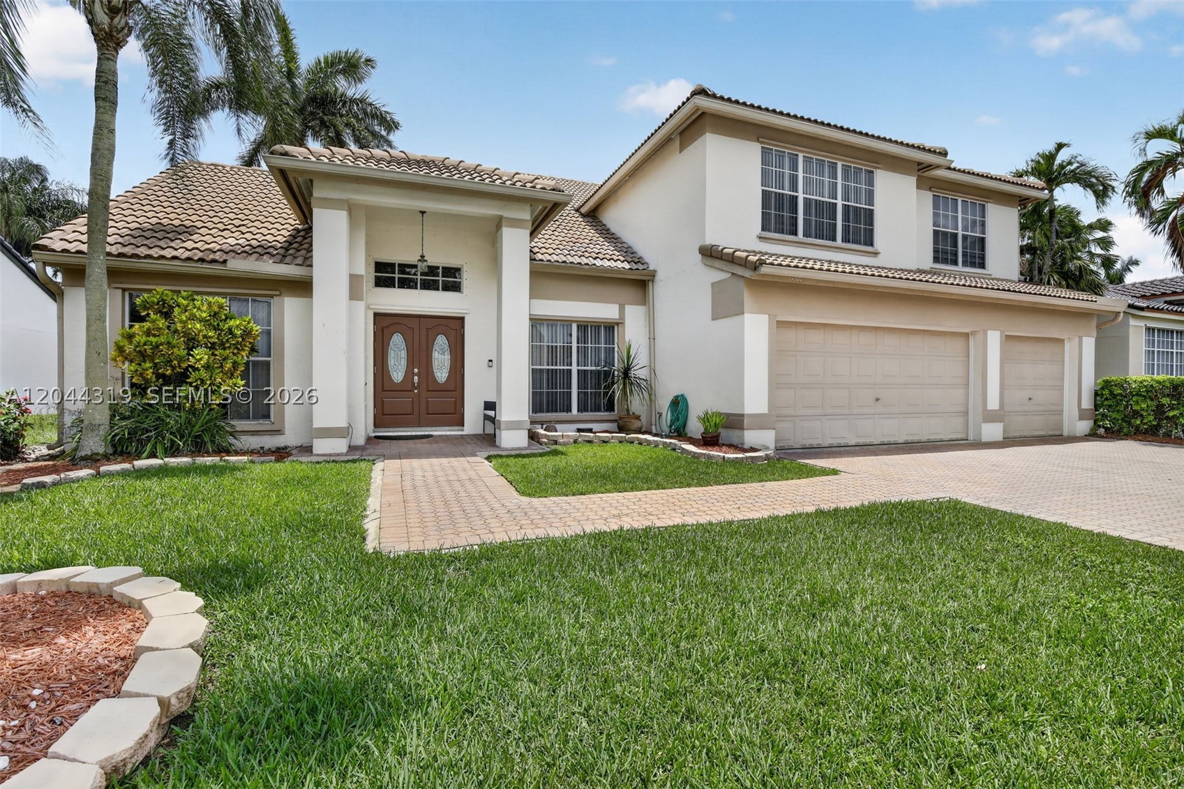 Experience refined South Florida living in this beautifully renovated 5-bedroom, 3-bath Dillon model pool home with a 3-car garage, set within the prestigious gated enclave of Chapel Trail Estates. Designed for effortless elegance, the bright open floor plan showcases soaring vaulted ceilings, sleek smooth finishes, LED lighting, porcelain tile and luxury vinyl plank flooring throughout. The chef-inspired kitchen impresses with raised-panel cabinetry, granite countertops, stainless steel appliances, an oversized island/serving bar and a walk-in pantry. Upstairs, the expansive primary suite offers a custom California closet and a spa-style bath with dual-sink vanity, Roman soaking tub, custom rain shower and frameless glass enclosure. Generous secondary bedrooms are complemented by a first-floor guest suite, den or private office with adjacent full bath. The grand family room flows seamlessly outdoors to a screened patio, sparkling pool and spa, lush tropical landscaping and an impressive multicar driveway. Enjoy 24-hour gated security, top-rated schools and a premier location near I-75, dining, shopping and Rose G. Price Park, featuring lighted tennis, basketball and ball fields, pools, shaded playgrounds, walking/jogging paths and community event space. HOA includes fiberoptic cable TV, Peacock and internet.