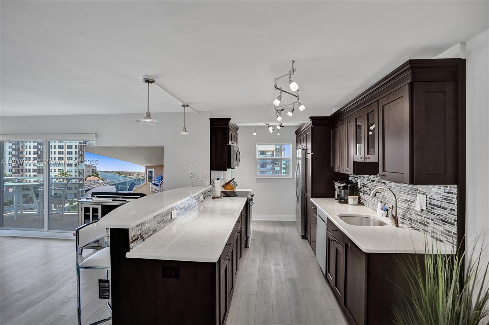 Beautifully updated 2-bedroom, 2-bath corner unit in highly desirable Hillsboro Beach is move-in ready. Recently freshly painted with new baseboards and newer flooring throughout, this residence offers a bright, modern feel from the moment you walk in. The floor plan features a spacious open kitchen with island seating, stainless steel appliances, stone countertops, and endless water views, making it the perfect space for entertaining. Impact glass surrounds the living area, filling the home with natural light and panoramic views. The primary suite includes a walk-in closet, upgraded vanity, and multiple additional storage closets. Enjoy electric window shades on your double sliding glass doors, allowing you to adjust the ambiance with the touch of a button. Step outside to your large wrap-around balcony and take in breathtaking views of both the Intracoastal Waterway and the beach with this Southeast & Western exposure—a rare combination of views that truly sets this unit apart. After a day at the beach or boating, unwind in the heated resort-style pool which sites on the Intracoastal. Boaters will love the community dock accommodating vessels up to 40 feet,with NO FIXED BRIDGES, offering quick and easy ocean access. Additional conveniences include laundry facilities on each floor, secure building access, and a peaceful, well-maintained community.This is the perfect coastal retreat—updated,stylish, & surrounded by the best of Hillsboro Beach living.Only 7 units per floor.