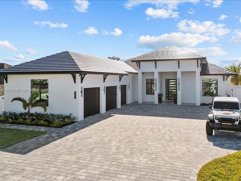 Experience exceptional craftsmanship and modern luxury in this brand-new custom-built residence completed in 2025. Situated on a generous 0.51-acre lot with no HOA, this stunning estate offers 5 bedrooms, 5 full bathrooms, and 1 half bath, with 3,337 square feet of living area and 5,088 square feet under roof.
Designed with elegance and functionality in mind, the home features soaring ceilings, porcelain tile flooring throughout, impact-resistant windows and doors, and an impressive 10-foot custom front entry door. The gourmet chef's kitchen is equipped with premium Thermador appliances, a 36-inch cooktop, wine cooler, custom pantry, and high-end finishes that make entertaining effortless.
The spacious primary suite and secondary bedrooms feature custom-built closets, while two high-efficiency A/C systems provide year-round comfort. Smart-home features include Ring security cameras installed around the property and a full sprinkler system.
Step outside to your private outdoor retreat featuring a covered patio with beautiful yellow pine wood ceilings, marble flooring, and a fully equipped outdoor kitchen complete with a built-in Alfresco barbecue grill. The fenced backyard offers plenty of space for a future pool, recreation, or outdoor enjoyment. A rare opportunity to own a meticulously designed custom home offering luxury finishes, premium construction, and exceptional outdoor living in one of Port St. Lucie's most desirable locations. Schedule your private showing today