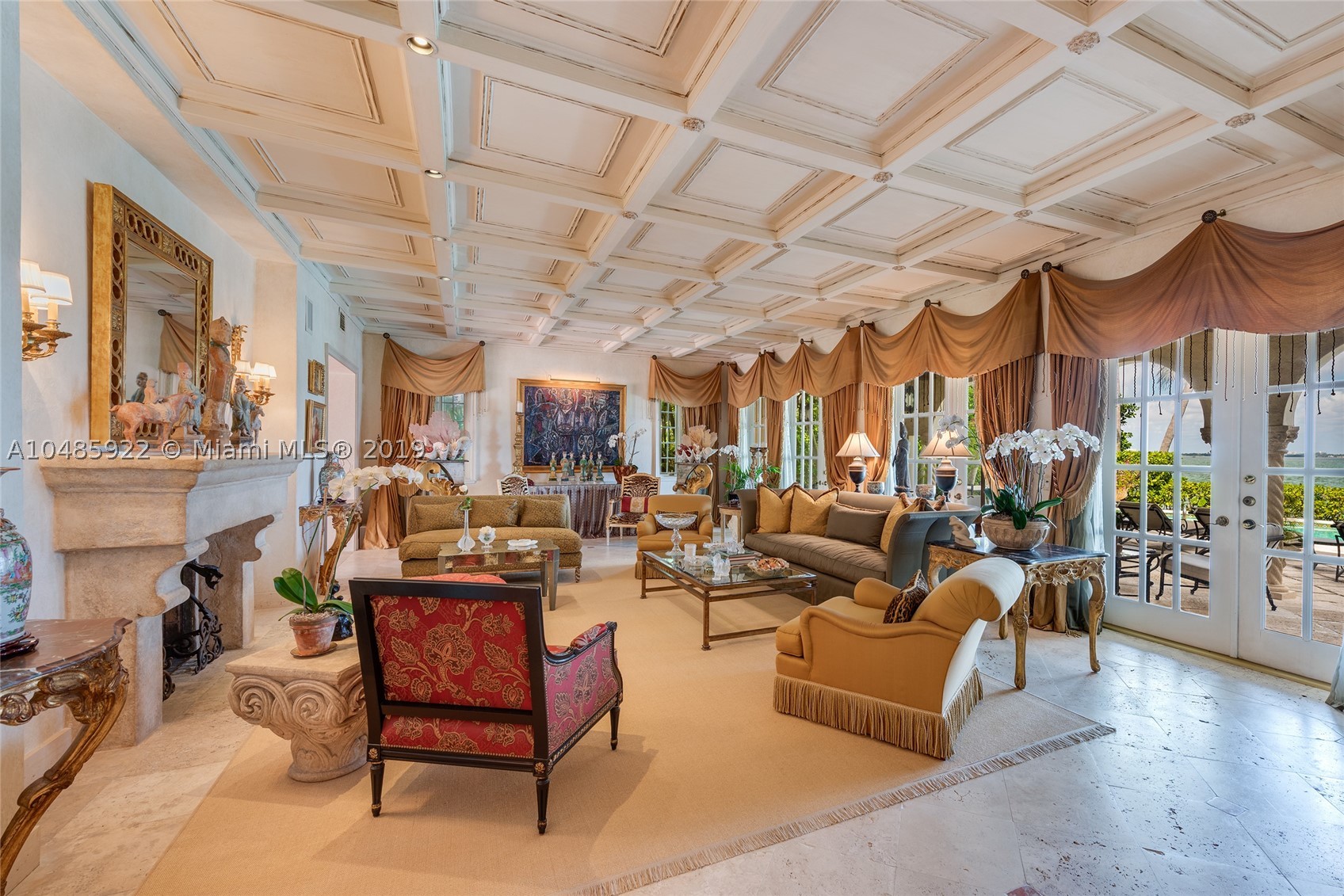Seller Motivated! Enjoy wide Biscayne Bay and stunning sunsets over the Downtown Miami skyline from this magnificent 2-story waterfront Mediterranean Revival estate designed by renowned architect Martin Luther Hampton. 6BR/8+2BA (incl. 2 private guest suites), & a romantic interior courtyard w/fountain. An impressive Great Room w/fireplace & Pecky cypress beamed ceilings greets leading to an expansive living room w/coffered ceilings, Saturnia marble floors, fireplace & formal dining room all w/open bay views. An elegant 2nd floor master suite sports a private sitting room, large balcony to the bay & balcony to courtyard. Spacious His & Her marble master bathrooms each w/walk-in closets. Entertain outdoor w/a large pool, covered loggia, & summer kitchen. Boat dock & 75.6’ of waterfront.