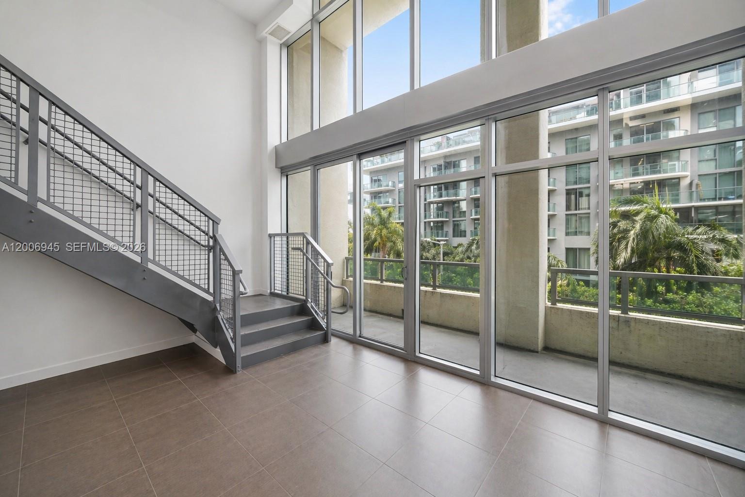 Stunning modern loft located in the highly sought-after 4 Midtown Miami in the heart of vibrant Midtown. This spacious 1 Bedroom + Den + 2 Full Baths residence features soaring double-height ceilings and dramatic floor-to-ceiling windows, flooding the space with natural light and showcasing lush city and greenery views. The open-concept layout offers incredible flexibility, with a large upstairs loft-style bedroom and a versatile den ideal for a home office, guest space, or additional living area. Enjoy sleek contemporary finishes, a private balcony, and a bright, airy atmosphere throughout. The unit has been professionally cleaned and prepared, making it move-in ready or ideal for immediate rental. 4 Midtown offers resort-style amenities including a pool, fitness center, concierge, and secure parking. Just steps from Midtown shops, Design District, Wynwood, and some of Miami’s best dining and entertainment.