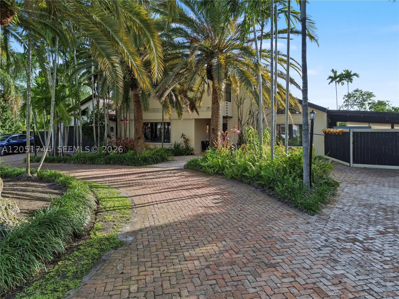 Tucked behind a private, palm-lined entrance in sought-after Calusa Club Estates, this 5-bedroom, 3-bathroom, two-story estate offers 2,776 square feet of resort-style living on an oversized 17,400 square foot lot. A brick paver driveway winds through mature royal and date palms to a gated courtyard entrance.

Backing directly to the golf course with a landscaped buffer and privacy wall, the home features vaulted wood beam ceilings, a stone fireplace, and an updated kitchen with an exposed brick archway, wood cabinetry, and stainless steel appliances. One bedroom is conveniently located downstairs, with the option to convert a second for added flexibility. A dedicated cinema room adds rare luxury, and the upstairs primary suite includes a private balcony with flex space.

Enjoy true Florida living with a pool and attached spa, covered terrace, pergola-shaded seating, and a fenced, landscaped yard overlooking the course. The garage is air-conditioned. Recent 2019 updates include a concrete patio, CBS perimeter wall, and wood fencing.

Located in Flood Zone X, no mandatory flood insurance required. Zoned for an A-rated school pipeline: Calusa Elementary, Arvida Middle (magnet), Miami Sunset Senior High (magnet). Minutes from Pinecrest, Palmetto Bay, and South Miami shopping and dining.

A rare opportunity to own a private, character-rich retreat backing the golf course. Schedule your private showing today.