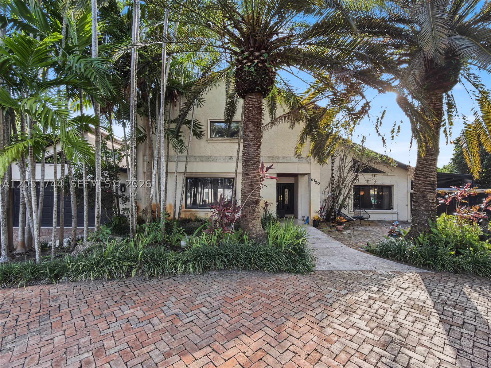 Tucked behind a private, palm-lined entrance in sought-after Calusa Club Estates, this 5-bedroom, 3-bathroom, two-story estate offers 2,776 square feet of resort-style living on an oversized 17,400 square foot lot. A brick paver driveway winds through mature royal and date palms to a gated courtyard entrance.

Backing directly to the golf course with a landscaped buffer and privacy wall, the home features vaulted wood beam ceilings, a stone fireplace, and an updated kitchen with an exposed brick archway, wood cabinetry, and stainless steel appliances. One bedroom is conveniently located downstairs, with the option to convert a second for added flexibility. A dedicated cinema room adds rare luxury, and the upstairs primary suite includes a private balcony with flex space.

Enjoy true Florida living with a pool and attached spa, covered terrace, pergola-shaded seating, and a fenced, landscaped yard overlooking the course. The garage is air-conditioned. Recent 2019 updates include a concrete patio, CBS perimeter wall, and wood fencing.

Located in Flood Zone X, no mandatory flood insurance required. Zoned for an A-rated school pipeline: Calusa Elementary, Arvida Middle (magnet), Miami Sunset Senior High (magnet). Minutes from Pinecrest, Palmetto Bay, and South Miami shopping and dining.

A rare opportunity to own a private, character-rich retreat backing the golf course. Schedule your private showing today.
