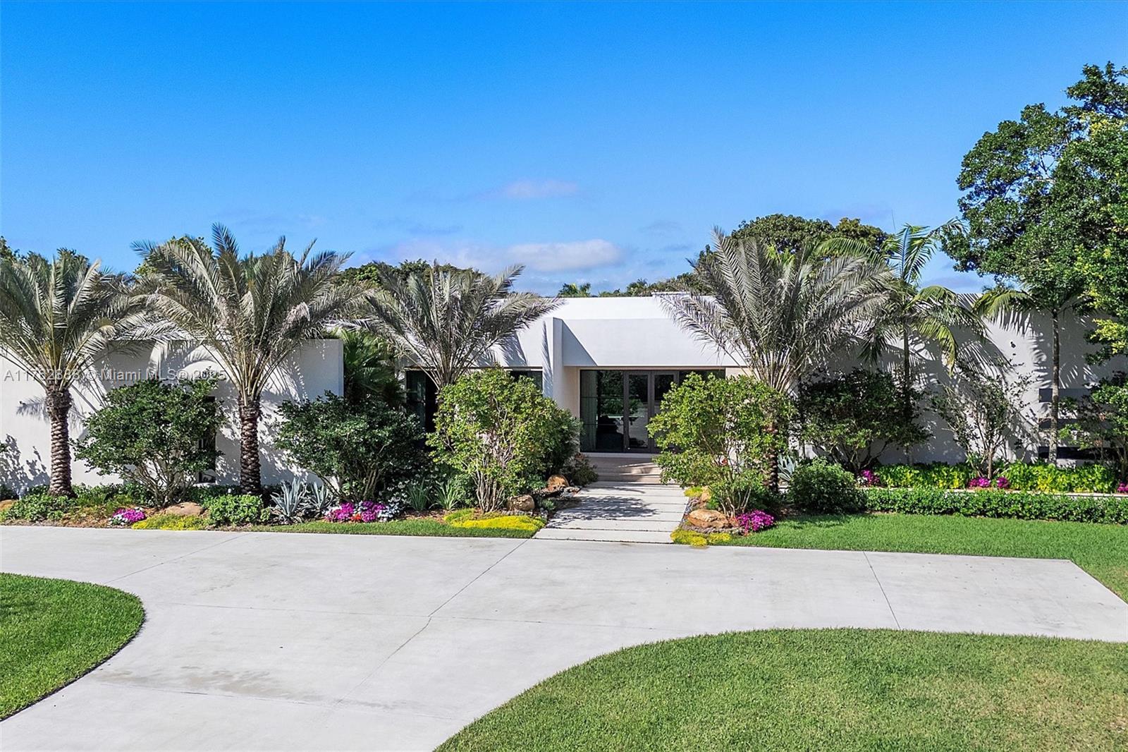 Modern Luxury Meets Private Oasis in Southwest Ranches. Nestled on nearly 4.5 acres of professionally landscaped grounds, this stunning modern estate blends contemporary design with ultimate privacy. Featuring luxury finishes and top-tier appliances, every space exudes elegance and comfort. Floor-to-ceiling glass blurs the lines between indoors and out, filling the home with natural light and serene views. The gourmet chef’s kitchen, spa-like bathrooms and expansive living areas provide the perfect retreat, while the Control4 smart home system ensures seamless automation. Enjoy lush outdoor space, entertain guests, or relax in total privacy. Located near A+ private schools, top shopping and fine dining, this home provides seclusion without sacrificing convenience. Schedule your tour today!
