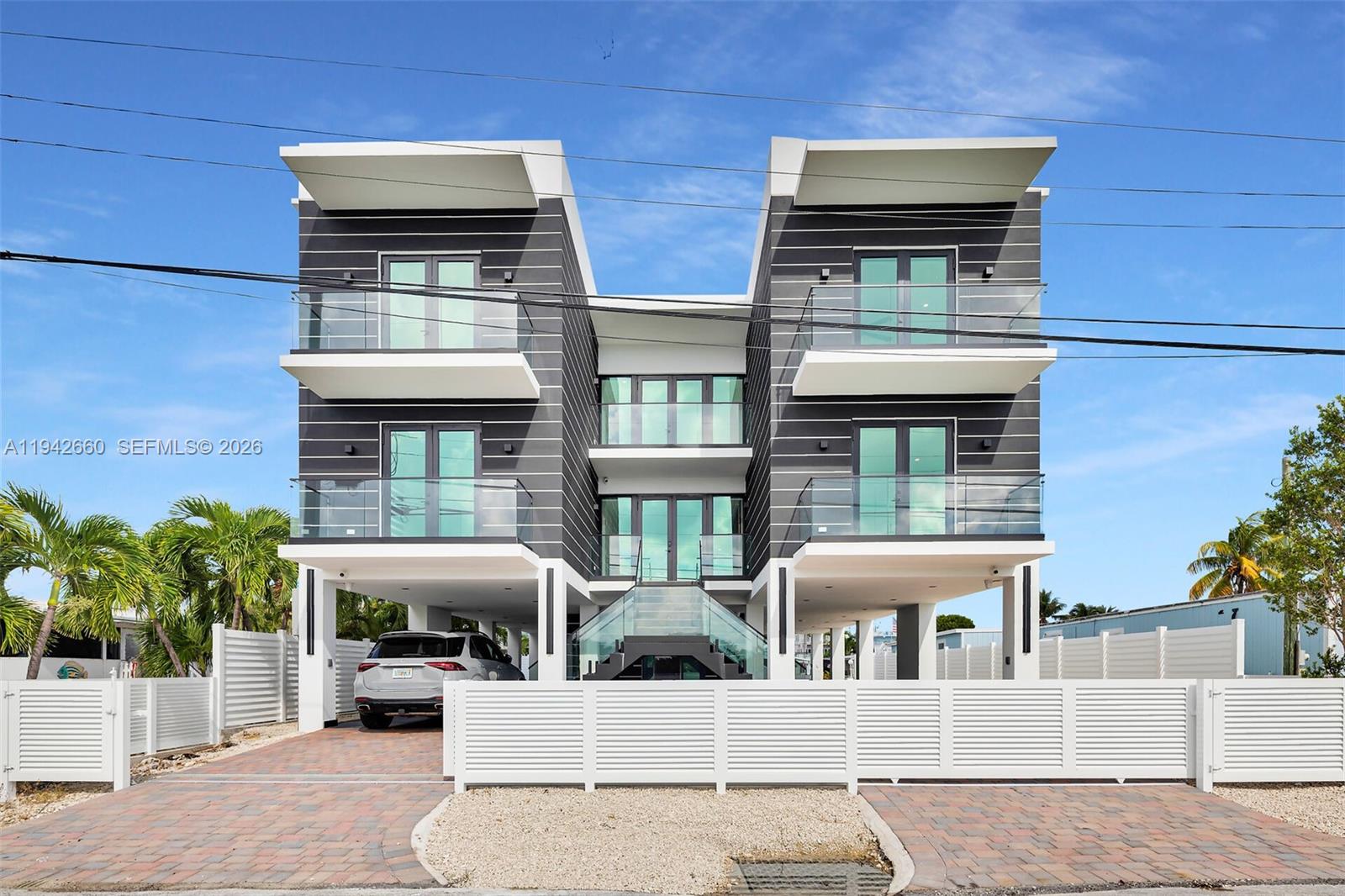 Stunning New Three-Story Bay View Residence. This Light-Filled 5-Bdrm, 4.5-Ba enjoys nightly sunset views. State-Of-The-Art Kitchen & Luxurious Finishes Throughout. 3 Generously sized ensuites, walk-In closets, and lavish bathrooms. Expansive Roof Top Terrace with wet bar and kitchen. Step into an open living area that effortlessly flows to the entertainment area and chef's kitchen. Enjoy indoor-outdoor living with multiple balconies, a waterfront roof top terrace complete with a built-in bar and summer kitchen, and direct access to a half bath. The home is designed for entertaining while capturing spectacular sunsets year-round. For those who cherish the outdoor allure of the Keys, the concrete dockage with deep water direct access beckons. Your personal gateway to the crystal-clear waters, embark on boating adventures, fishing expeditions, or diving explorations right from your doorstep. This home caters to the water enthusiast, offering a privileged lifestyle. A pool and elevator to all floors. In every aspect, this modern haven is a celebration. A harmonious fusion of luxury, nature, and waterfront living. This is more than a home; it's an invitation to savor life's most indulgent moments against the backdrop of stunning sunsets and the allure of the open water. Your waterfront paradise awaits - where every day feels like a vacation, and every sunset is a masterpiece. Seller Financing Available.