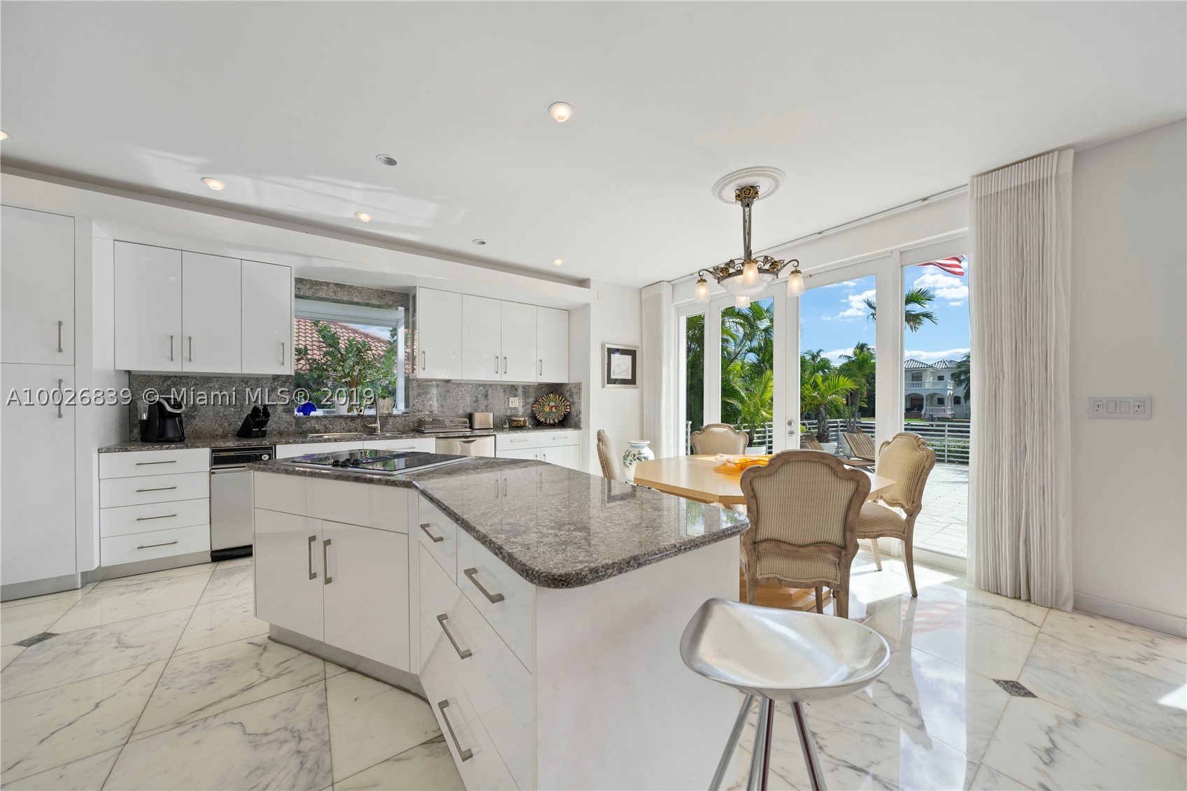Wake up to spectacular Florida sunrise and enjoy beautiful sunsets in this oasis!  Breathtaking water views!  Light & bright 2 story gorgeous custom built pool home in gated community at prestigious Golden Beach w/150ft of water frontage including a protected slip for boat up to 35ft plus extra large dock space for a yacht & ocean access.  House was constructed by current owner using only the finest materials, Italian Carrara marble throughout, vaulted ceilings, open modern kitchen, safe impact windows or accordion or rolladen shutters, wine storage room, office on 1st floor overlooking water.  Relax on private roof top sunbathing deck.  Spacious 2 car garage.  Close to beautiful Aventura and Sunny Isles Beach!