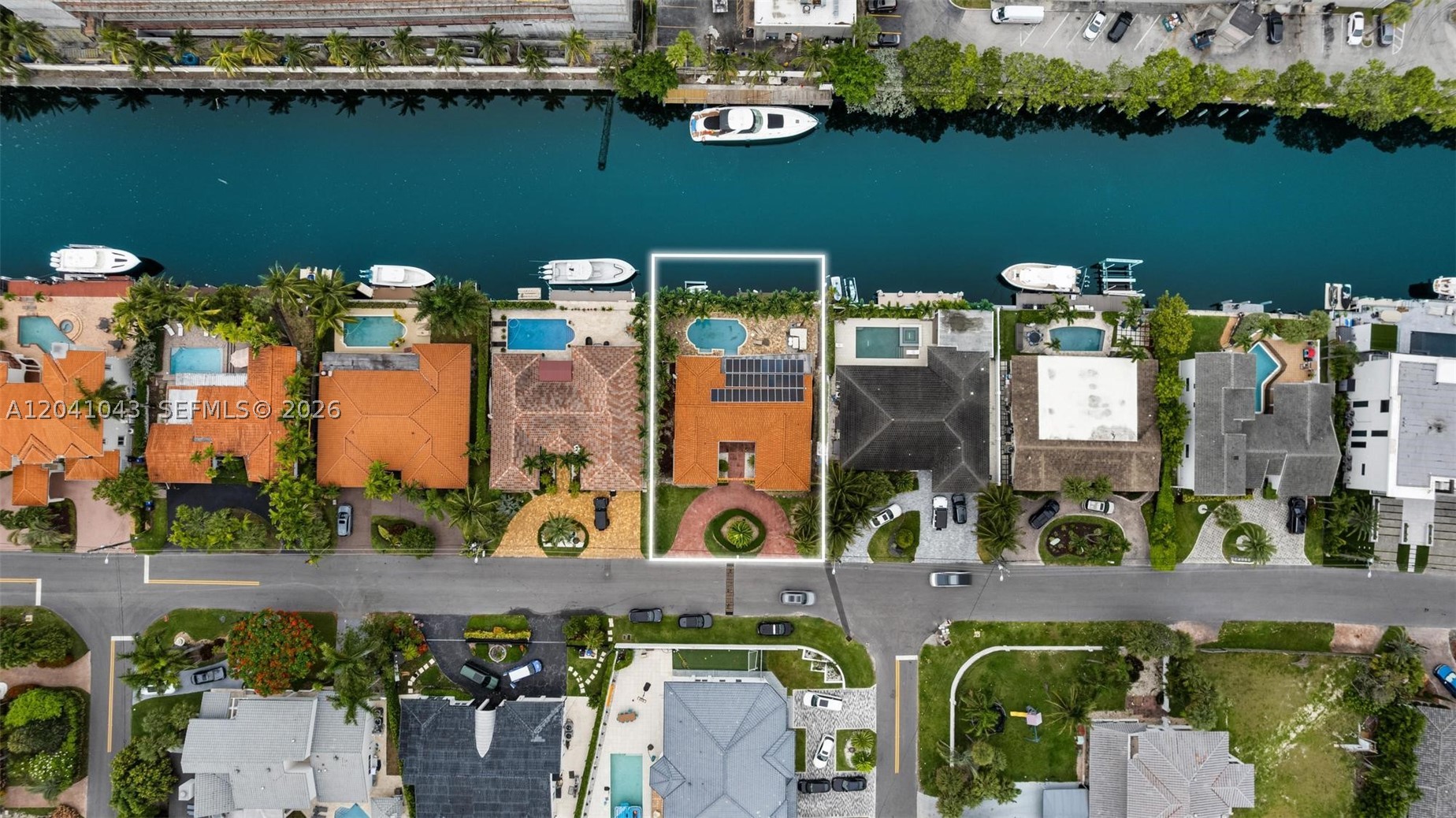 UNBEATABLE VALUE! Discover the ultimate waterfront lifestyle in the exclusive, gated enclave of Eastern Shores. This spectacular 4-bedroom, 3-bathroom home boasts 80 feet of premium water frontage with direct ocean access. Inside, the bright, open-concept layout is flooded with natural light, showcasing a luxurious primary suite complete with an en-suite bath and massive walk-in closets. A gourmet chef's kitchen features high-end appliances and custom finishes. The backyard serves as your personal oasis, featuring a private dock, heated pool, and lush, tropical landscaping. Equipt with eco-friendly solar panels and located just minutes from pristine beaches, fine dining, and luxury shopping, this property redefines coastal elegance.
