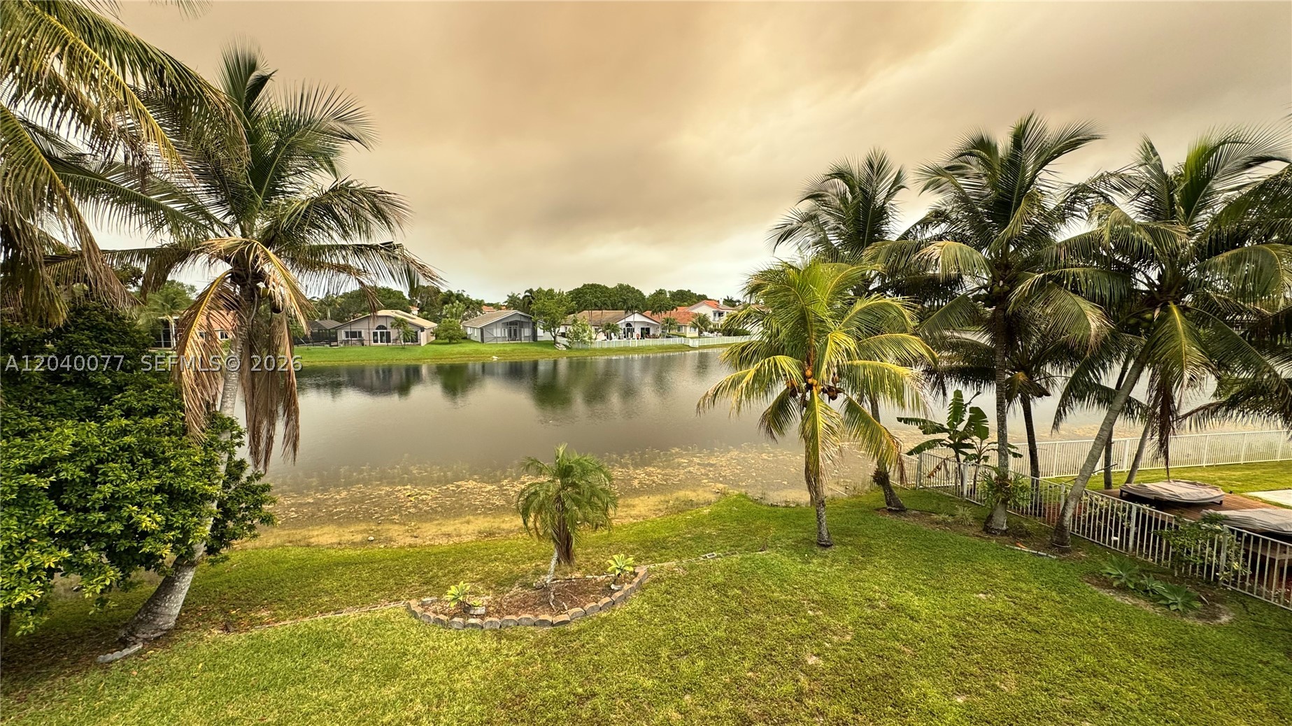 Rare opportunity to own a waterfront home in one of Pembroke Pines' most desirable communities! This original-owner residence offers 4 bedrooms, 3.5 bathrooms and is situated on an oversized 10,000+ square foot lakefront lot with beautiful water views and endless potential. The home features an updated kitchen, while the remainder of the property is largely in original condition and ready for renovation, making it the perfect opportunity for buyers seeking to renovate and personalize a lakefront home to their own taste and style.

The spacious floor plan provides a solid foundation for a modern transformation, and the expansive backyard offers plenty of room to create your own outdoor oasis. Enjoy peaceful lake views and a yard enhanced by several mature fruit trees, adding beauty, shade, and the opportunity to harvest fresh fruit right from your own property. There is currently no pool, allowing the next owner to design the outdoor space exactly to their vision.

Properties with this combination of lot size, waterfront location, fruit trees, and renovation potential rarely become available. Whether you're looking to create your forever home or unlock the value of a prime waterfront property, this is an opportunity you won't want to miss. Bring your imagination and transform this exceptional lakefront residence into something truly special.