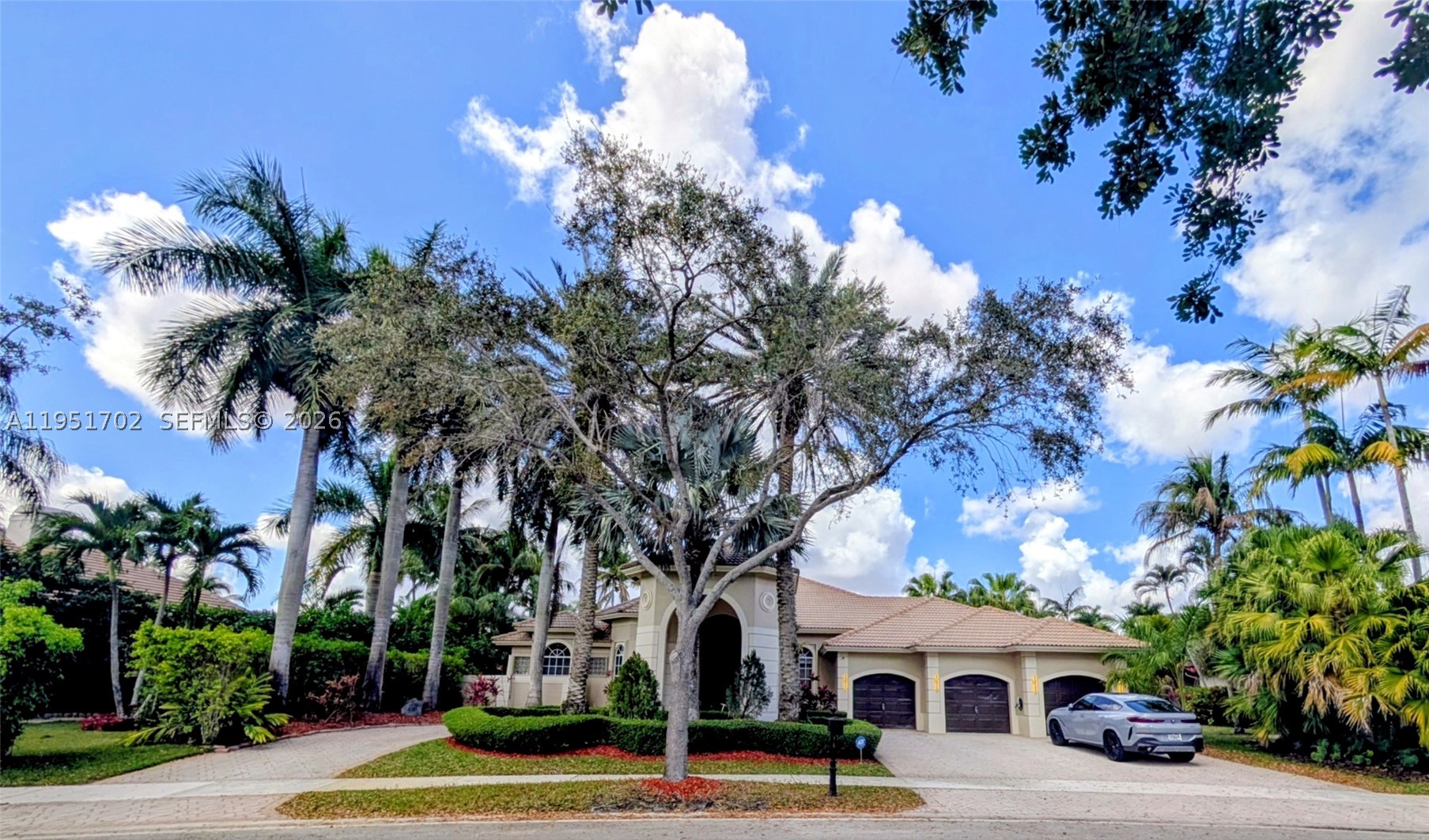 A rare opportunity to own a waterfront masterpiece on an oversized 19,197 SF cul-de-sac lot in the prestigious gated community of The Landings. This elegant residence blends timeless design with modern luxury, offering soaring ceilings, full accordion hurricane protection, and a thoughtful layout that delivers both sophistication and comfort.
The home features 5 spacious bedrooms, each with beautifully upgraded ensuite bathrooms, a stylish powder room, and a dedicated home office. The expansive principal suite includes a private office/gym and tranquil panoramic views of the shimmering lake and resort-style pool.
The chef’s kitchen is a true showpiece, boasting rich Italian-style cabinetry, quartzite countertops and backsplash, and brand-new premium stainless-steel appliances. It opens seamlessly to the warm family room and custom bar area—an entertainer’s dream with sweeping water and pool views.
Step outside to your private oasis: a resort-style saltwater pool, full summer kitchen, and covered grill area designed for year-round enjoyment. A grand porte-cochere and circular brick-paver driveway create unforgettable curb appeal, complemented by a 3-car garage with EV charging and a whole-home water filtration system.
Perfectly located just minutes from A-rated schools, parks, shopping, and Weston Town Center, this home offers the lifestyle today’s discerning buyers seek—luxury, privacy, and an unparalleled waterfront setting. A must-see for those who refuse to compromise.