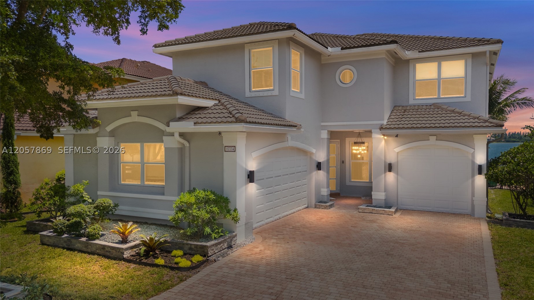Wake up to peaceful lakefront views in Sunset Falls, one of West Miramar’s most desirable guard-gated communities. This spacious 3,372 sq ft home offers 4 bedrooms plus a loft perfect for a 5th bedroom, along with bright open living areas, tile floors throughout, recessed lighting, zebra blinds, and beautiful lake views from multiple rooms.Designed for the way buyers live today, the flexible floor plan offers room to gather, work from home, entertain, or create privacy for guests and extended family. The home features two upstairs ensuites, plus a large downstairs bedroom set up as an in-law quarter, creating an ideal layout for multi-generational living, visitors, or extended stays.The heart of the home features a newly installed kitchen from late 2025 with quartz countertops and a fresh modern design, while all bathrooms have been fully renovated with upgraded finishes. Major updates include impact windows and doors, interior and exterior repainting completed in 2021, two AC units with one brand-new unit installed in May 2026, a tank water heater, main-to-garage pipe replacement completed in May 2026, and additional interior plumbing updates around 2022.Outside, enjoy expansive lakefront views, exterior lighting, and a sprinkler system, creating a relaxing setting for everyday living and entertaining. Sunset Falls offers resort-style amenities, including a clubhouse, fitness center, pool,pickleball, tennis courts, playgrounds, and a secure guard-gated entrance.Conveniently located near Publix, Target, Miramar Regional Park, I-75, The Shops at Pembroke Gardens, dining, shopping, parks, and entertainment. A move-in ready lakefront Sunset Falls home with the space, upgrades, flexible bedroom layout, lake views, and lifestyle buyers are looking for in the heart of West Miramar.