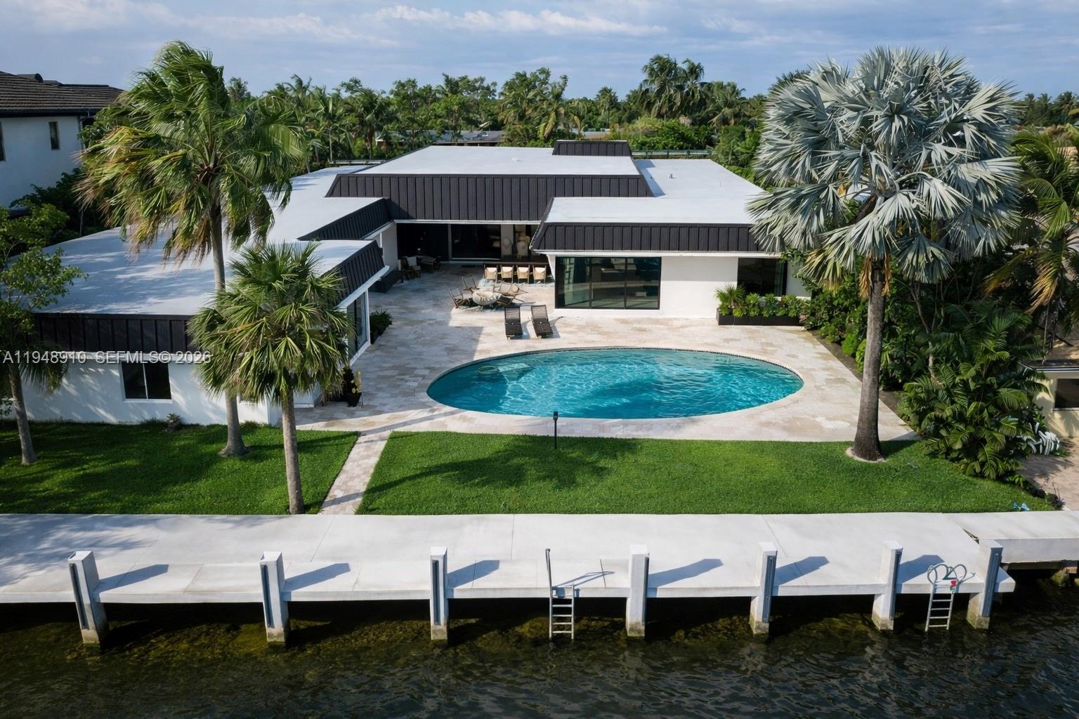 100 FT of prime waterfront | 4,258 SF under A/C | 13,428 SF lot An exceptional waterfront residence offering refined modern upgrades, expansive water frontage, and resort-style outdoor living. Meticulously renovated with premium finishes and top-tier appliances, this home delivers both elegant and functionality—ideal for entertaining and multigenerational living. Main Residence 3 Bedrooms with all-new lighting and custom closet build-outs 3 Brand-New Full Bathrooms New Italian-designed kitchen cabinetry Sub-Zero refrigerator & freezer Wolf microwave ASKO dishwasher Range with oven laundry room 2-car garage New roof Partial impact glass windows and doors New security & camera system with dedicated CCTV monitoring screen Outdoor Living 90-FT newly constructed concrete dock 9-FT deep pool Gas BBQ entertaining patio bar Expansive waterfront ideal for boating and outdoor enjoyment In-Law Suite (Private & Self-Contained) 1 Bedroom with custom closet build-out Full bathroom Built-in laundry Kitchenette Separate entrance for privacy and flexibility This turnkey waterfront home combines luxury, privacy, and thoughtful design—set on a generous lot with rare 100 feet of water frontage in one of Hollywood’s most desirable enclaves.