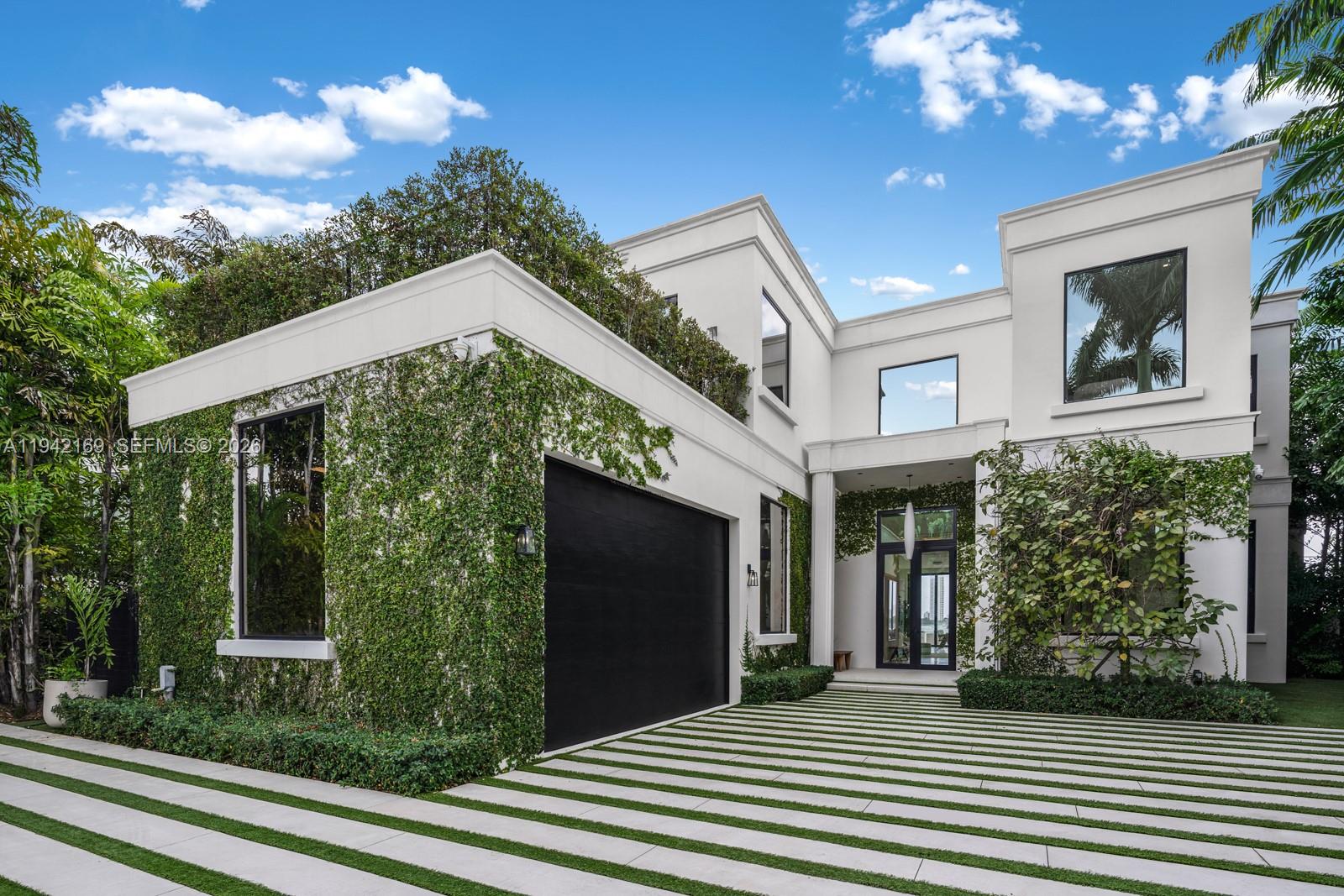 Step Inside With Me! This Modern Neo-Classical inspired estate embodies refined style and enduring sophistication on the Venetian Islands. Masterfully designed by CLF Architects and built by Brodson Construction, it was custom-built (not spec) with premium finishes and superior construction. Its iconic entry, crowned by soaring 25’ ceilings, reveals sunrise-facing interiors. Spanning over 10,000 sf per tax records, the home opens with a receiving room leading to a 64' grand social salon with formal dining and bayfront breakfast lounge. The culinary experience is anchored by an expansive eat-in island, Taj Mahal counters, gas cooktop, Wolf appliances, and views stretching toward the open waters. The stately primary wing impresses with a gallery-style entry hall leading to waterfront sleeping quarters, an intimate sitting lounge, 2 dressing rooms, and dual spa-like baths with soaking tub. An idyllic floor plan unfolds across 6 bedrooms, a media room, private office, fitness room, versatile staff quarters, and multiple sitting lounges, completing the home’s thoughtfully composed interiors. The outdoor experience is realized through lounging areas, a loggia with retractable screens, an outdoor TV, summer kitchen, covered dining, and sundeck with 42' pool. A private dock offers waterside seating along 105+ ft of Eastern Biscayne Bay breezes and a rooftop terrace provides additional hosting space with sunset views. A privacy gate, 2-car garage and generator complete this offering.