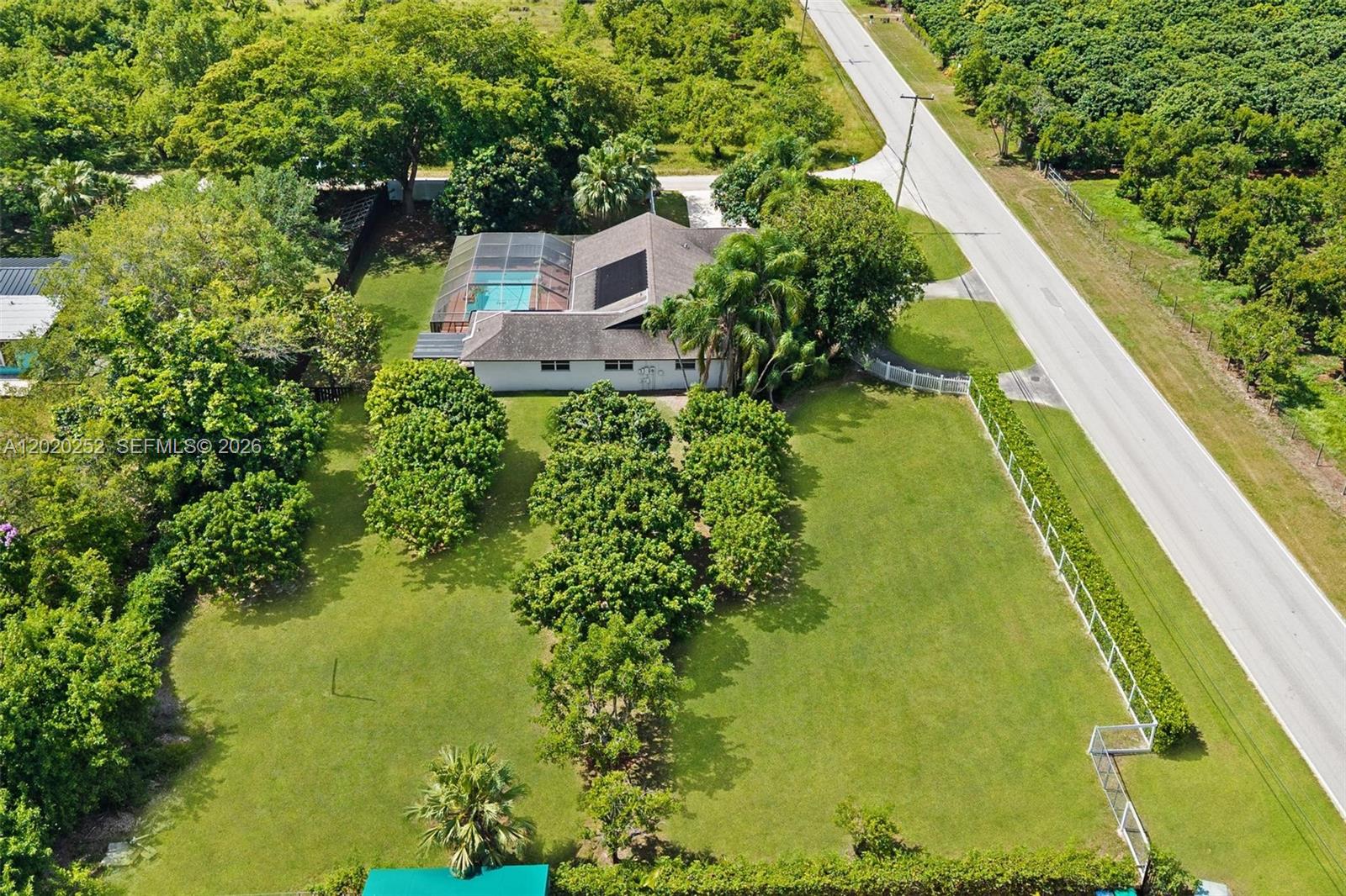 Welcome to your own Redland's private paradise— this beautifully maintained 4-bedroom, 2-bath pool home offers peaceful country-style living just minutes from the city, featuring an oversized corner lot, side-entry 2-car garage, and no HOA. Rich cedar vaulted ceilings add warmth and elegance throughout the home, while the modern gourmet kitchen showcases upgraded appliances, abundant cabinetry, oversized countertops, and picturesque views of the screened solar-heated pool. The spacious primary suite features elegant French doors leading directly to the pool area, large windows overlooking the lush fruit tree grove, a walk-in closet, and a spa-inspired bath with dual sinks, Jacuzzi tub, and separate shower. Additional highlights include impact-resistant windows, a whole-house reverse osmosis filtration system, and a thriving half-acre fruit tree grove with its own irrigation system. Schedule your private tour today!